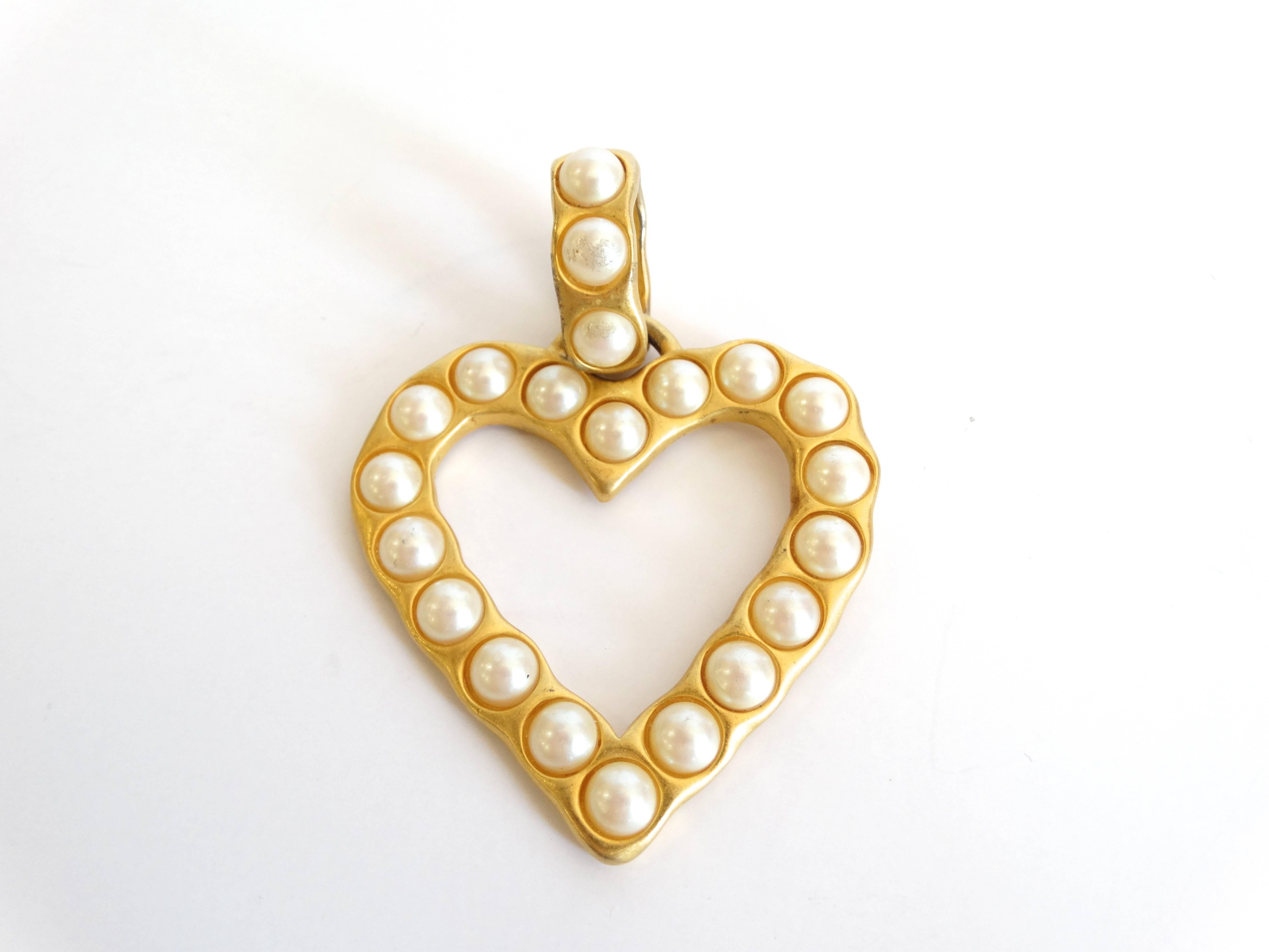 Fall in love with this adorable 1980s Givenchy pendant! In a romantic heart shape, cast in gold metal and accented with faux pearls. Wear this piece on any necklace of your choice. Stamped with Givenchy on the back as seen in detail shot. 3