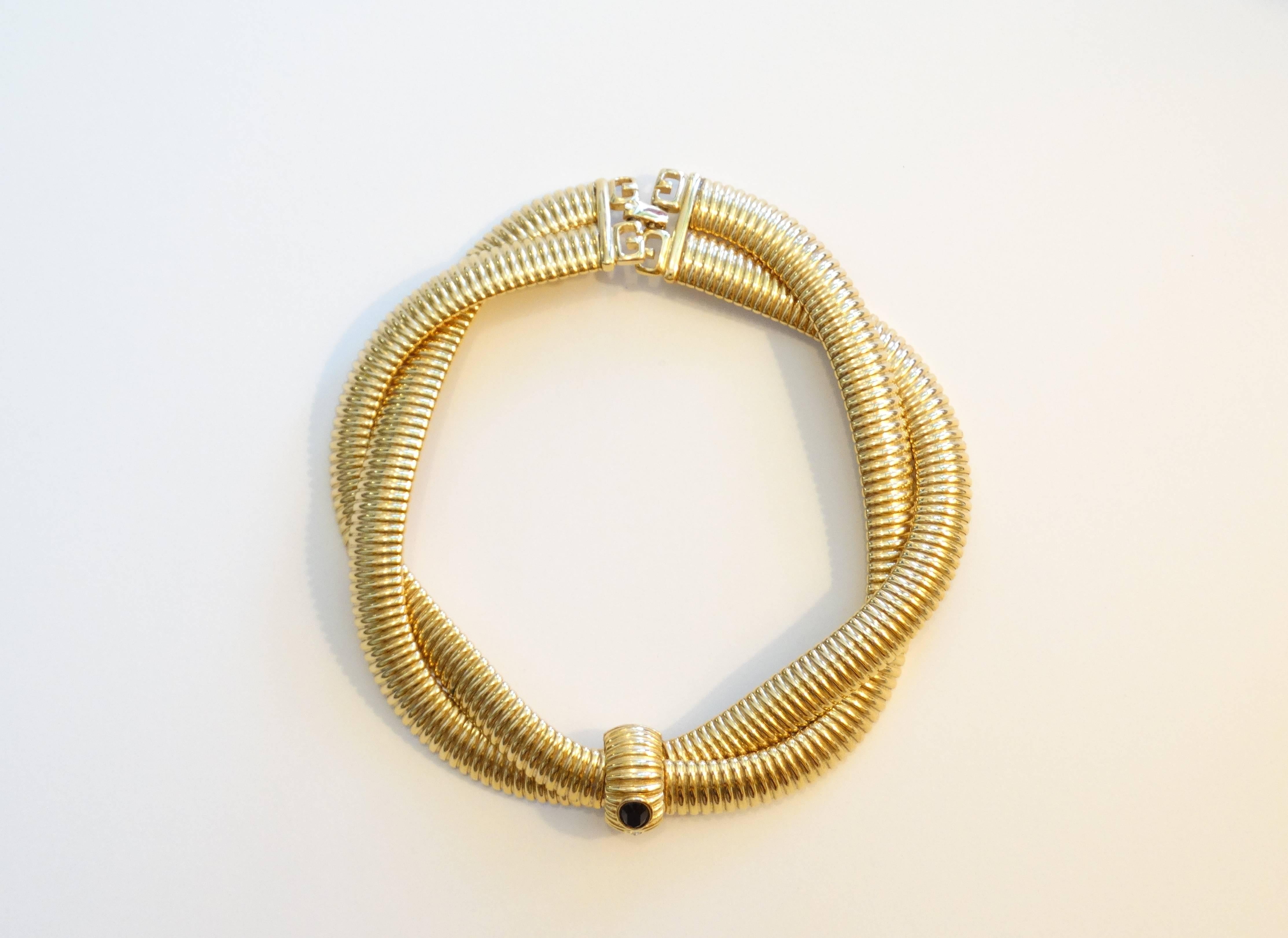 Woven 1980s Givenchy collar necklace! This piece comes to you in brilliant gold metal with a black gem at the center. Signature Givenchy logo Clasp. Signed Givenchy 

Total Length is 16 inches 