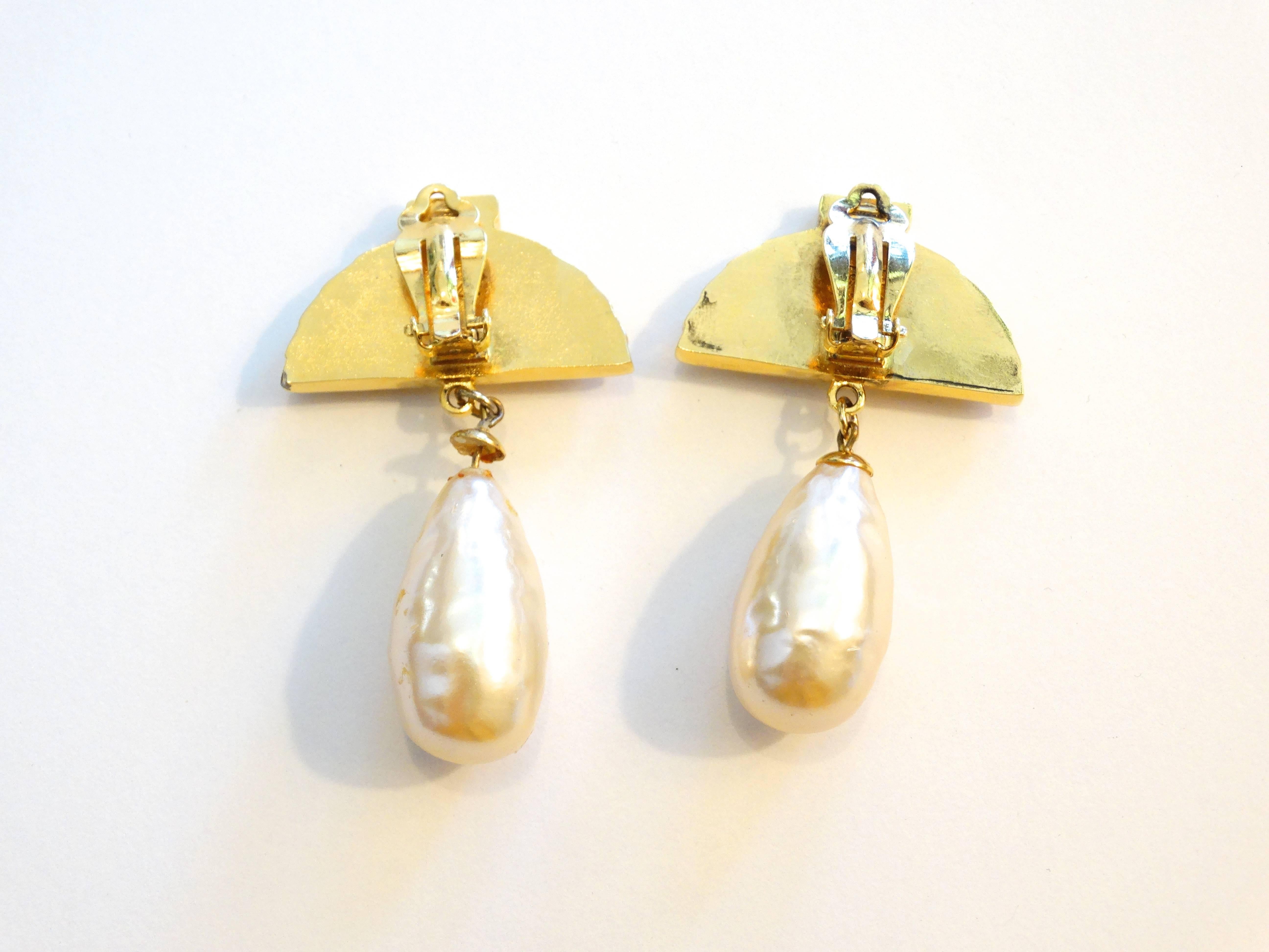 Beautiful fan statement earrings designed by Karl Lagerfeld gold tone with a large faux pearl. Signature watermark of Karl Lagerfeld on both earrings. Made in France 