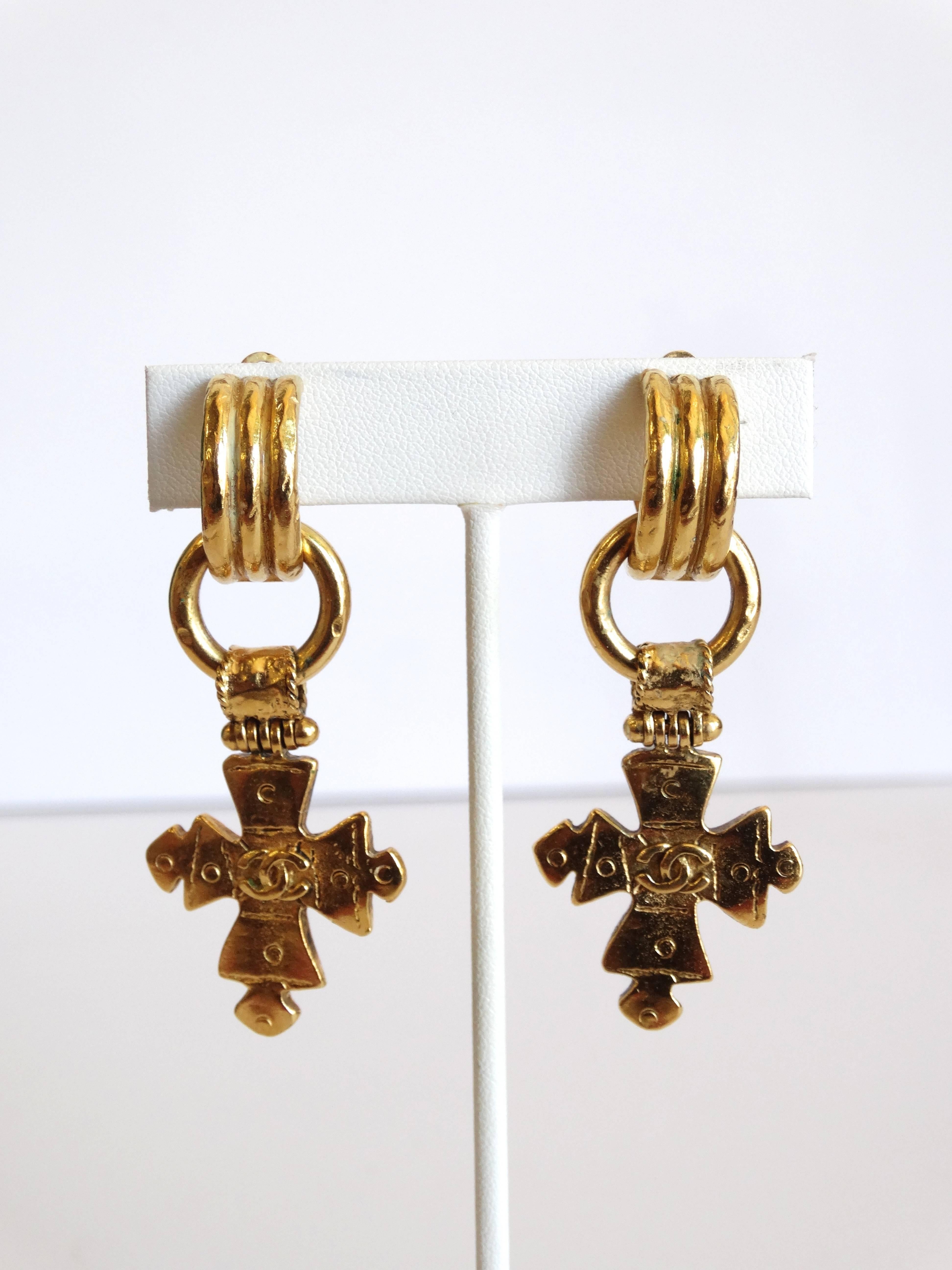 Incredible pair of Chanel cross earrings! From Spring 1994- these earrings come to you in a brilliant gold metal with double cc cross charms that are detachable- can be worn with or without. Made in France engraved on the back. They look truly