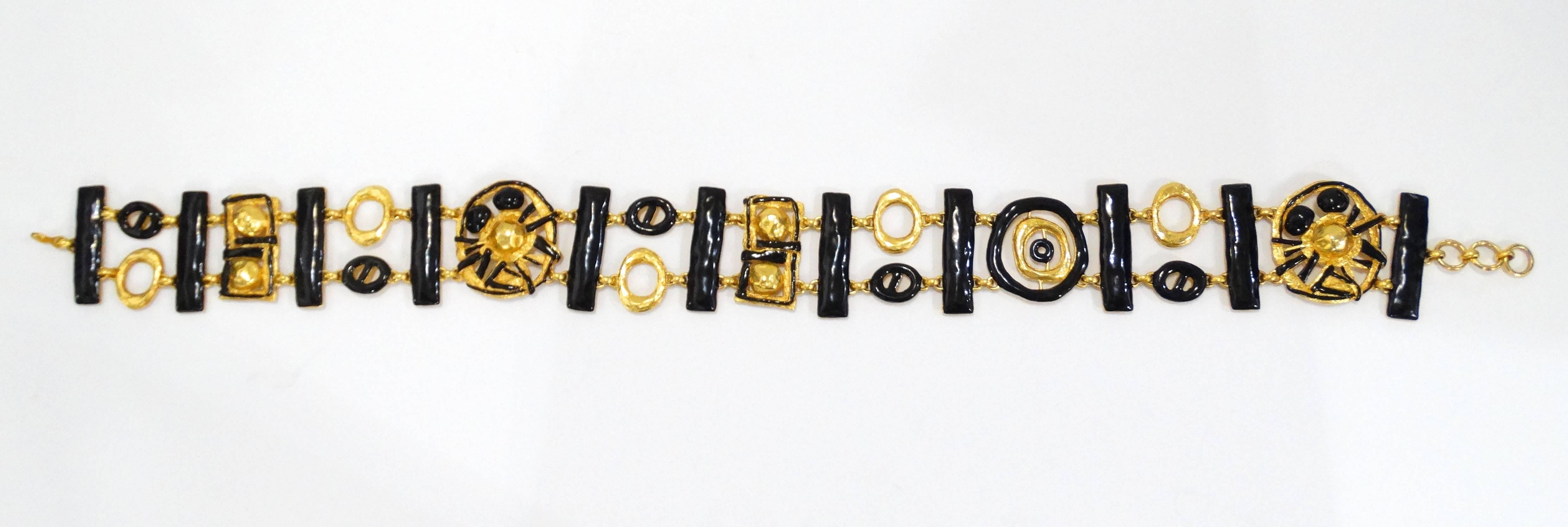 Rare and Fabulous this late 1980's Christian LaCroix chain belt with abstract geometric charms. This belt is cast in brilliant gold plated metal topped with black enamel details. Chain and hook closure. Signed Christian Lacroix
Made in France!