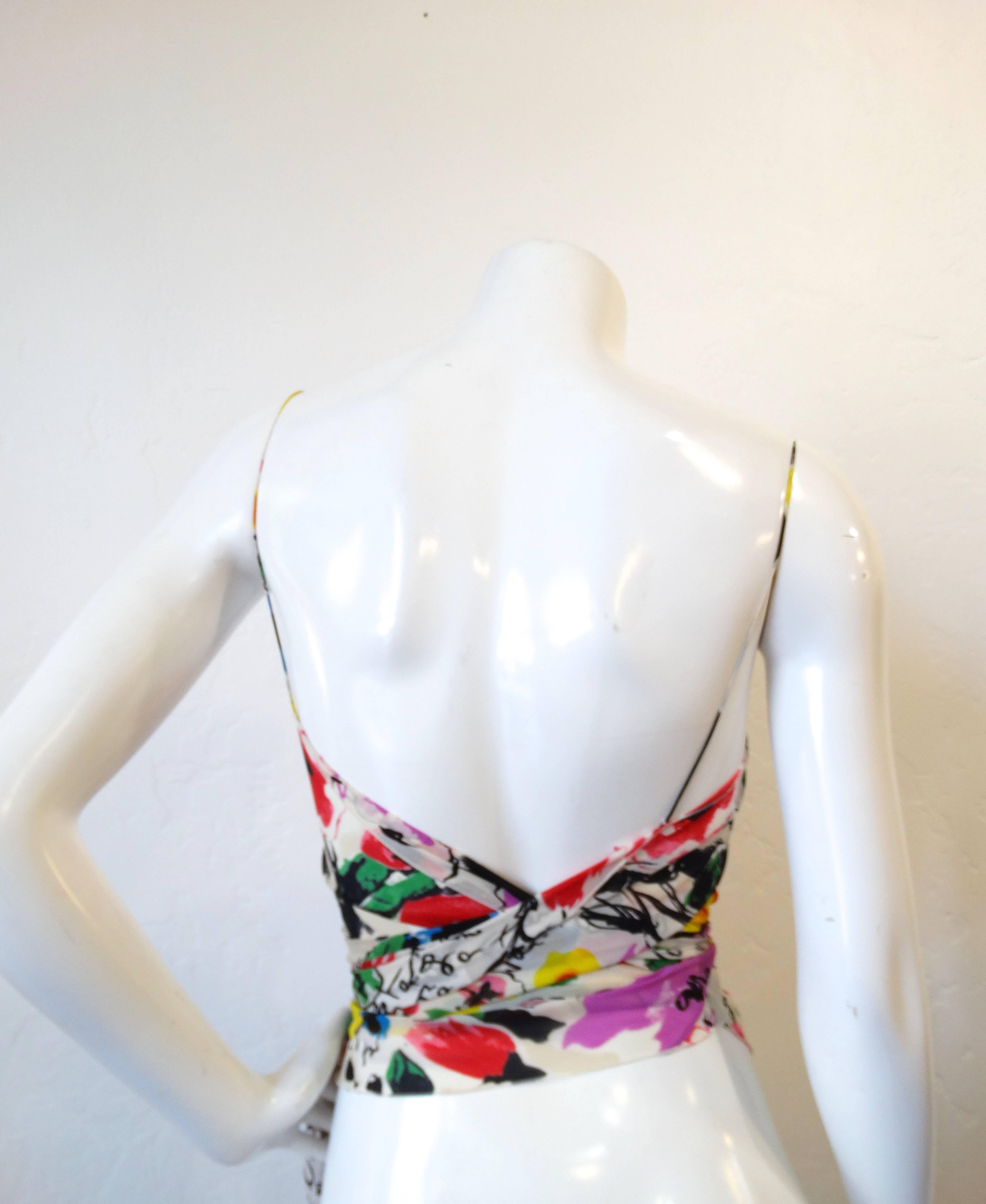 A beautiful piece from the late Sonia Rykiel, this lovely spaghetti string tank top has a bold floral print. Made of silk you can wrap this top around the waist the tie into a knot or bow. Fits a size 2 or 4 wear on its on or layer over a blouse or