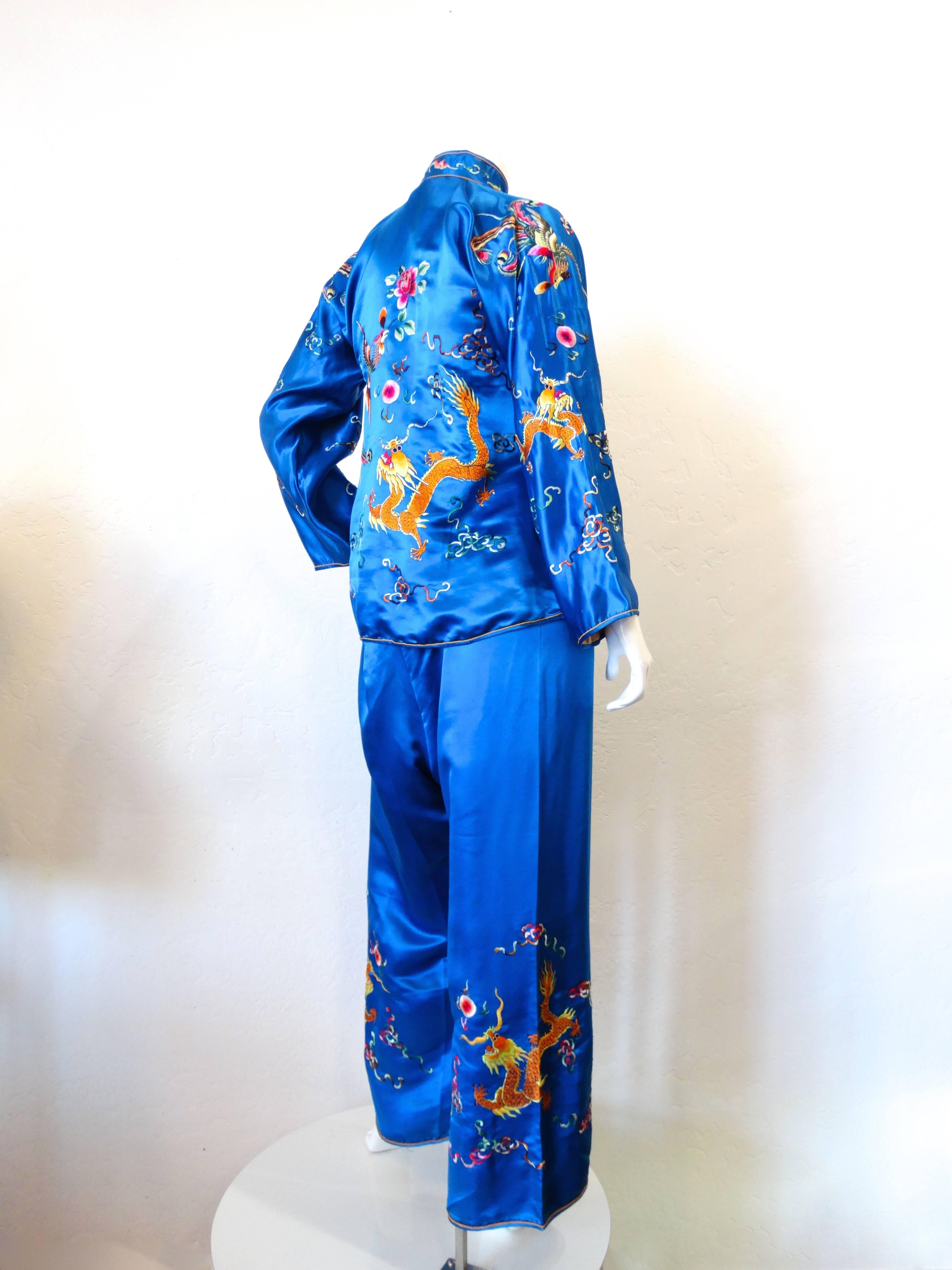 A beautiful Chinese satin pajama set in a brilliant blue silk! Embroidered with multicolored dragons, and the phoenix bird with floral motifs- this set looks incredible together or as separates! Fully lined interior in a peachy colored silk. Top