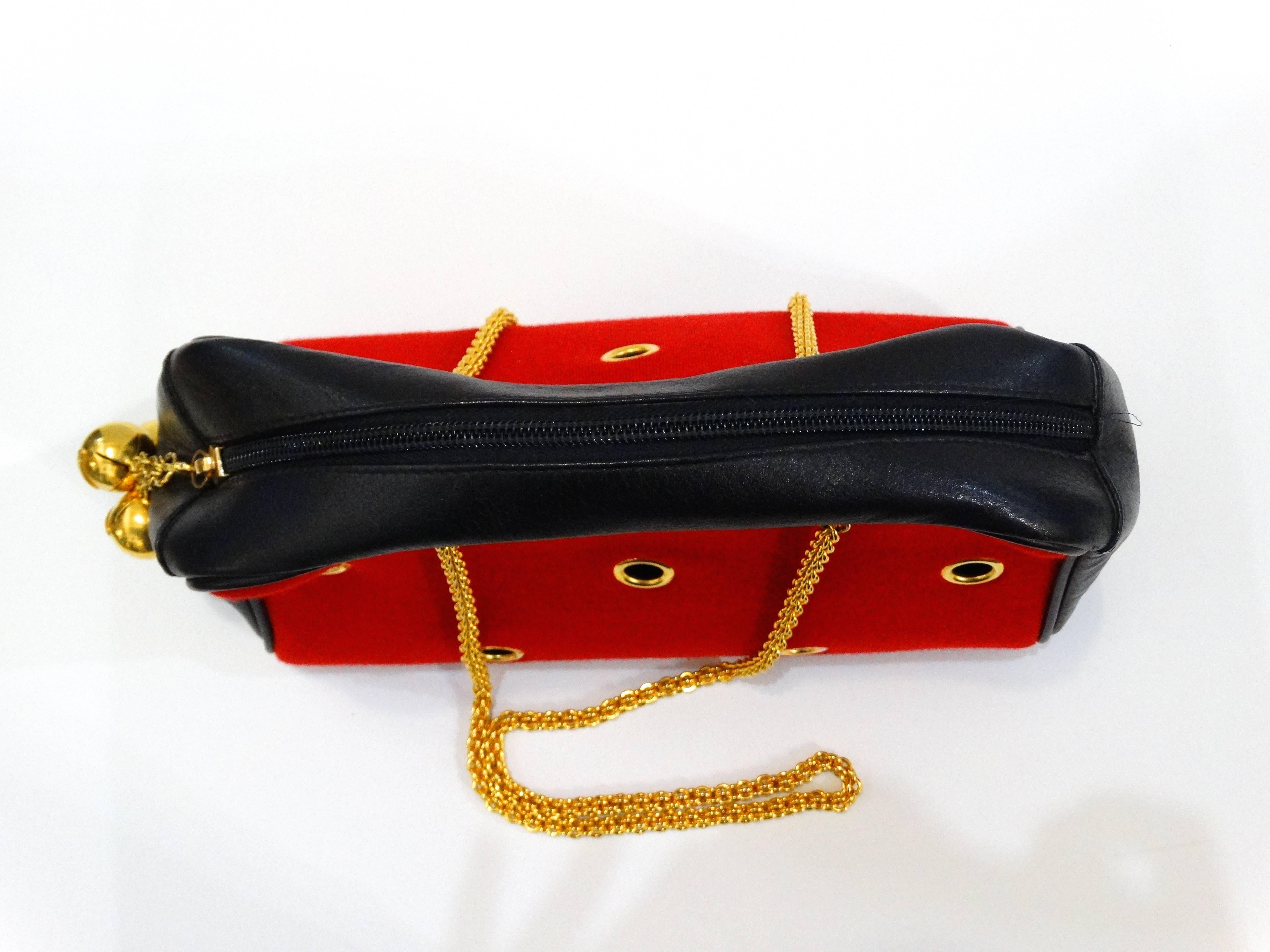 Incredible Moschino Redwall Grommet bag! Red cloth exterior with gold grommet details. Bell charm zipper pull with Moschino signatures. Long gold twisted chain straps. Great size 14inches x 8 inches x 4 inches 