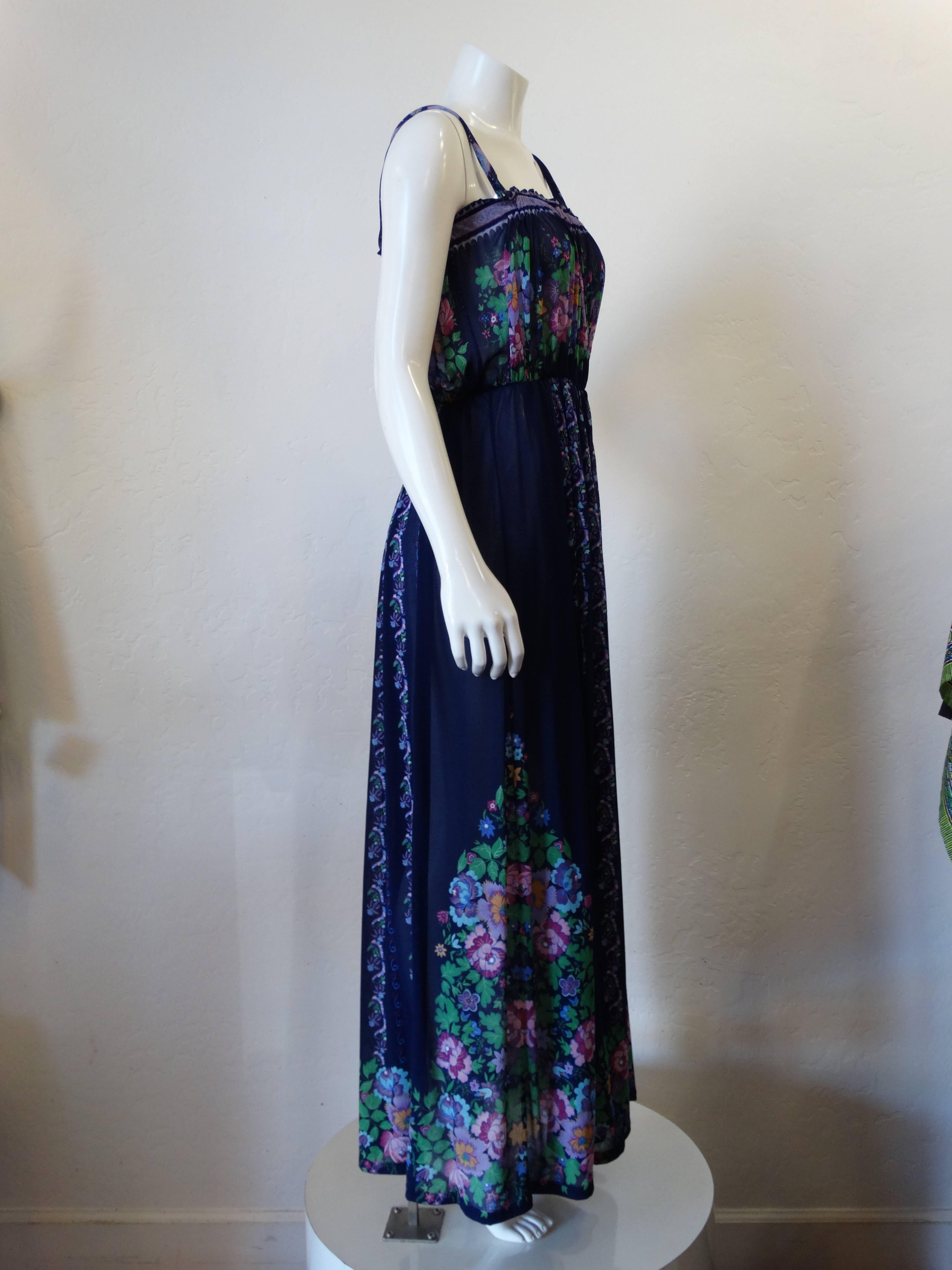 1970s maxi gown from the Israeli brand Gottex! Deep blue fabric printed with lilac and green florals! Elasticized waistline and bust with spaghetti straps. Slightly sheer. Best fits a size Small. 