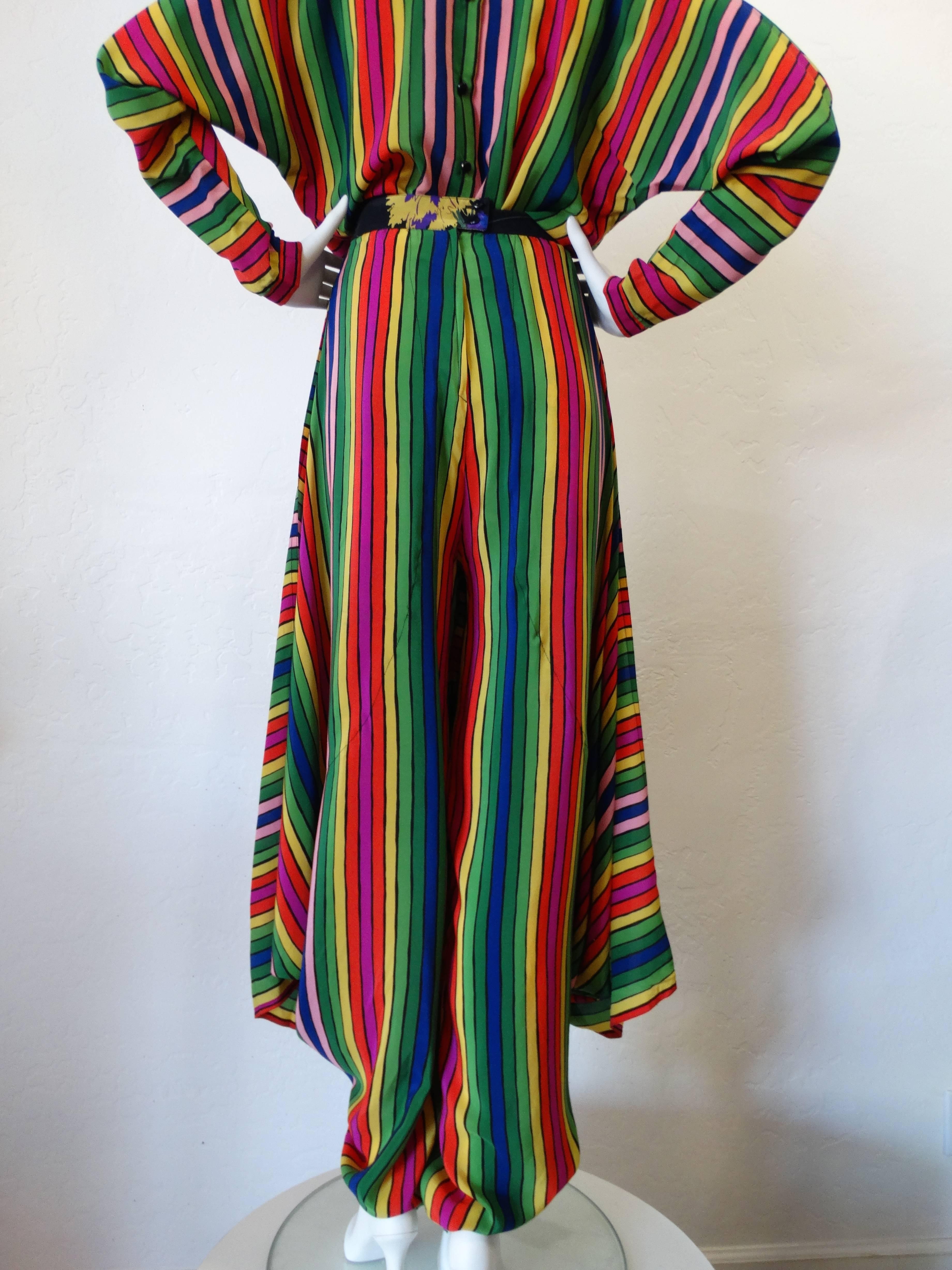 A very rare 2 piece blouse and pant combo set from the fabulous designer Fong Leng... this ensemble is made of 100% silk. The blouse is in a fabulous vibrant rainbow print with layers of Silk fabric in a zig zag pattern. Blouse cut is dolman style,