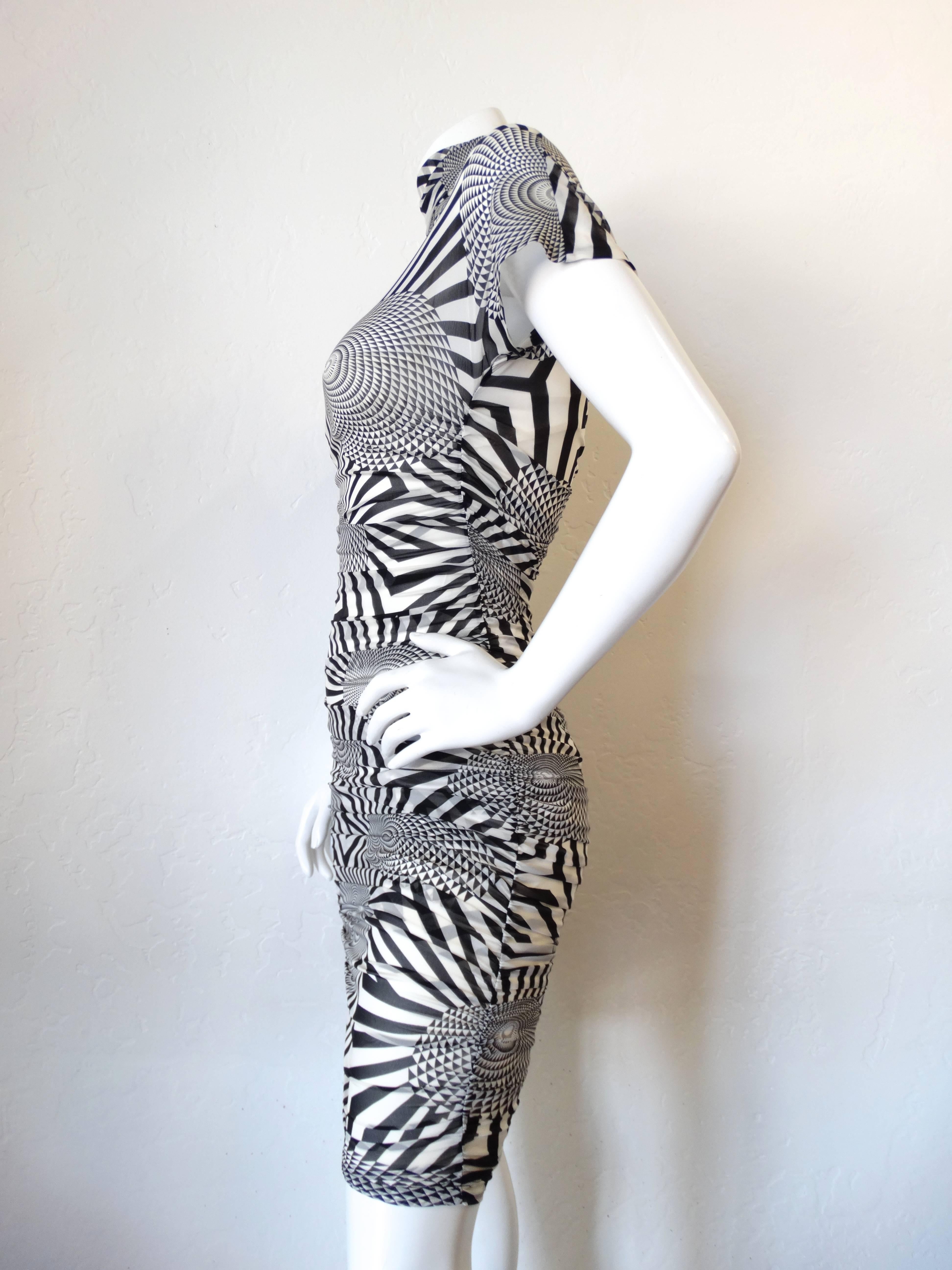 Dolce & Gabbana bodycon dress from the early 2000s! Sheer stretch fabric with black and white optical illusion print. Mock turtleneck neckline and short sleeve fit. Zips up the back.  Marked a size 40; best fits an XS/S though there is some stretch.