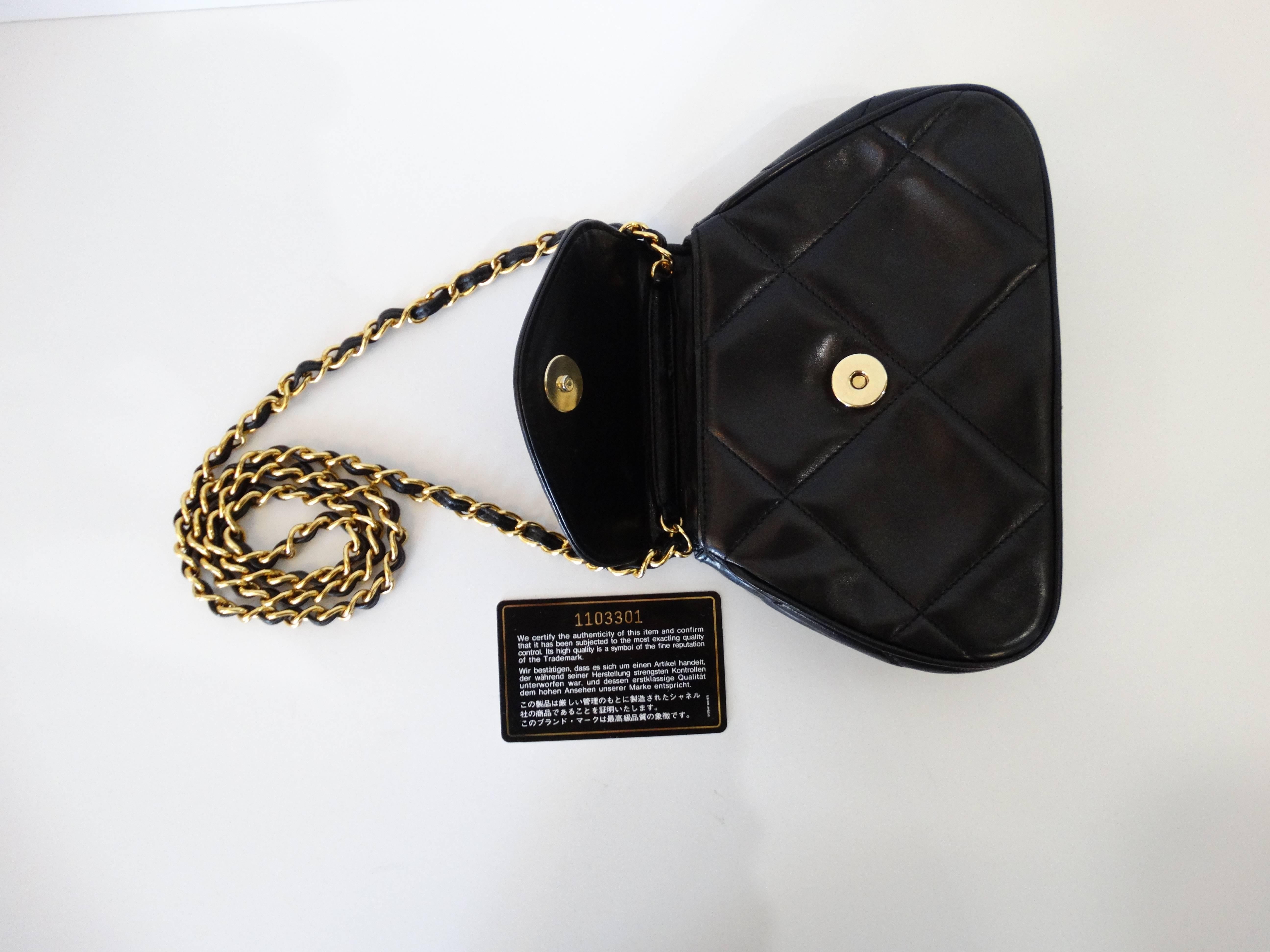 Adorable 1990s Chanel bag in the softest lambskin leather! Incredible rich jet black color makes this piece SO versatile! Iconic quilted pattern with CC logo stitched into the flap. Classic gold chain- easily tucked in and worn as a clutch. In