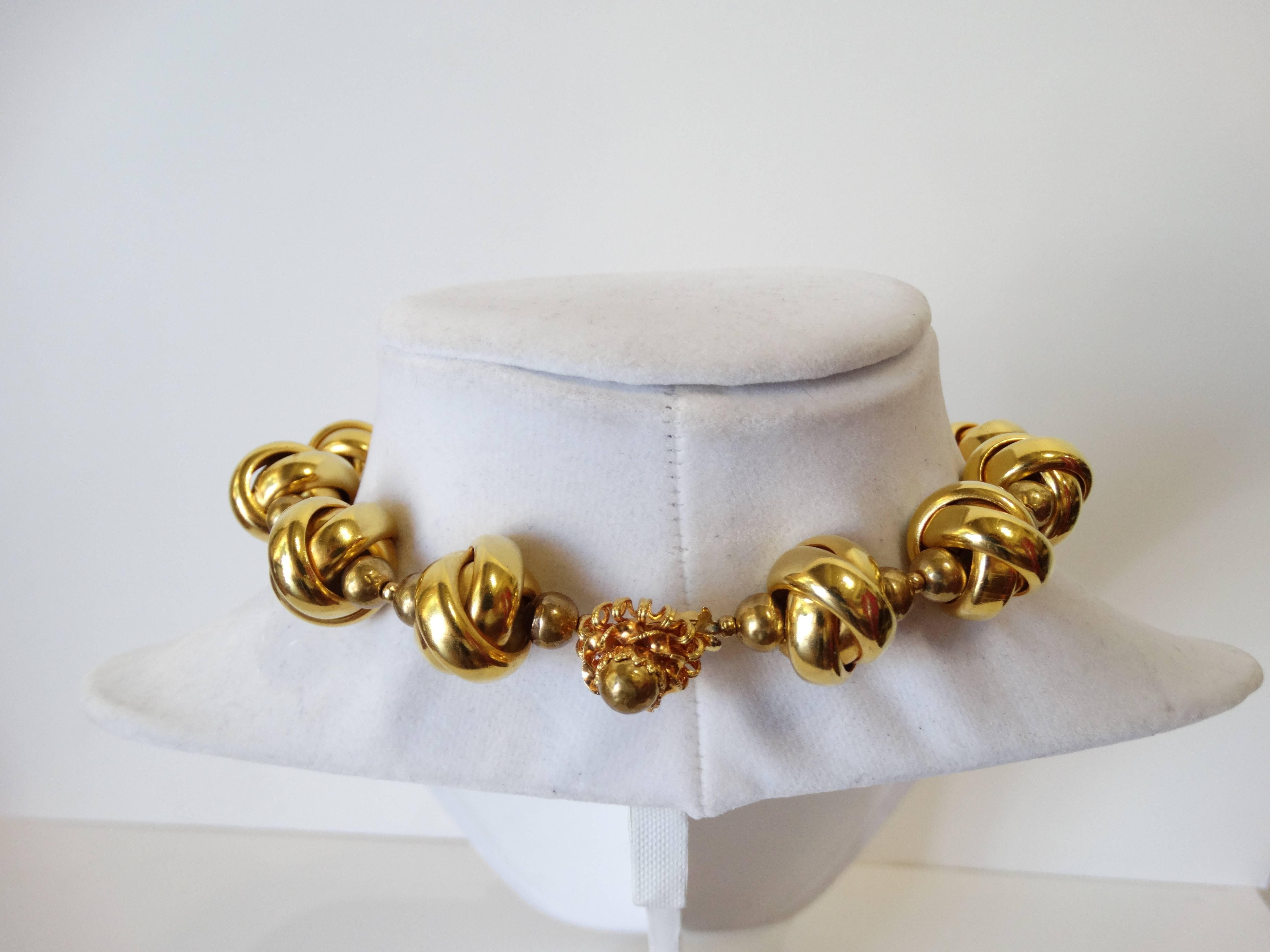 Amazing 1970s William De Lillo Necklace! Knot shaped beads cast in a brilliant gold metal. 3 knots dangle in the center Closure at the back of the neck. Signed at the back of the clasp. Delillo Great statement necklace 

Total length 16 inches