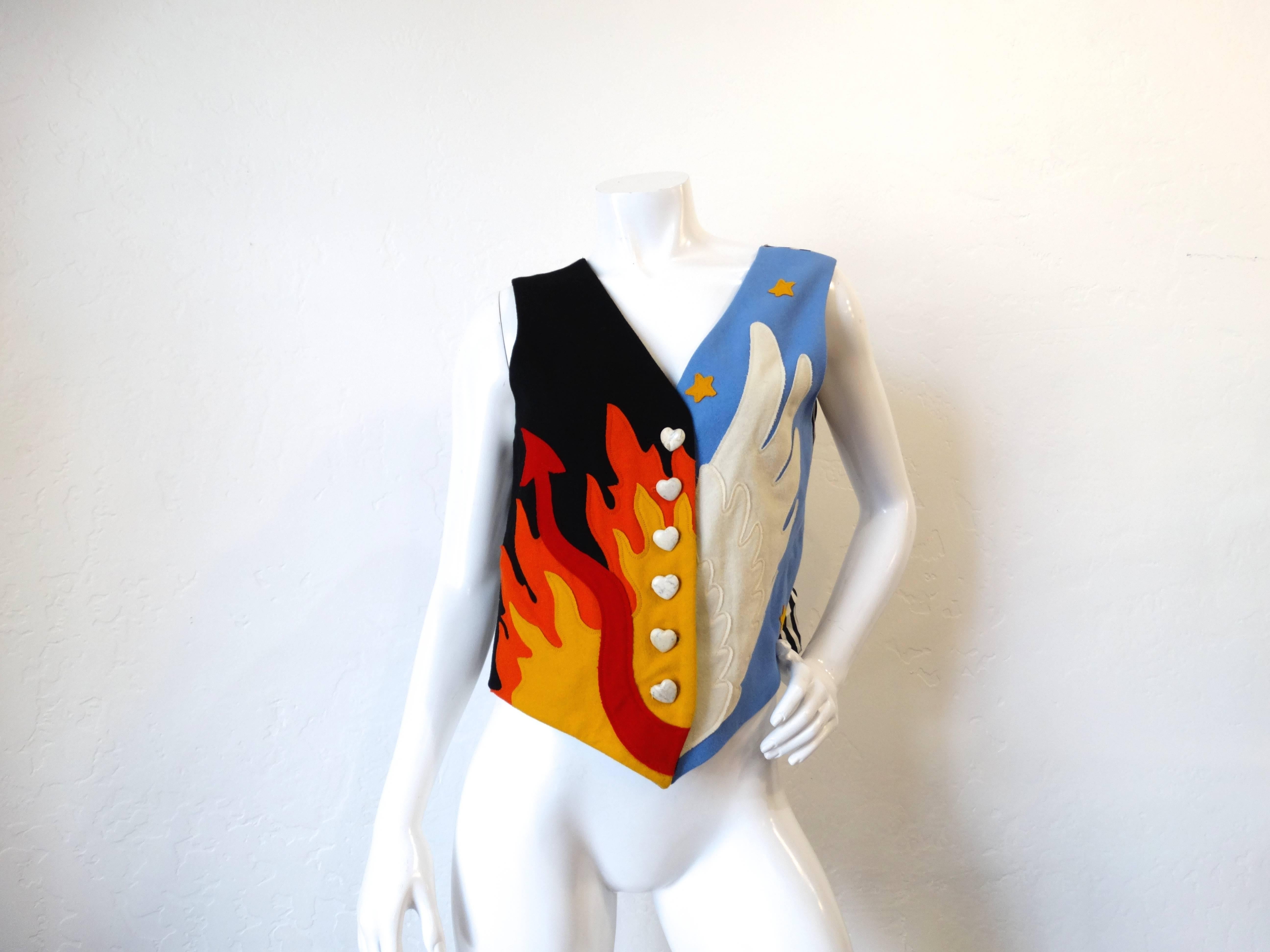 This rare vintage Moschino vest features a double graphic wool felt patchwork front, one black side with gold and orange flames with a devil's tail Hell motif and the other a sky blue with gold stars and cream angel wing in a Heaven motif, and a