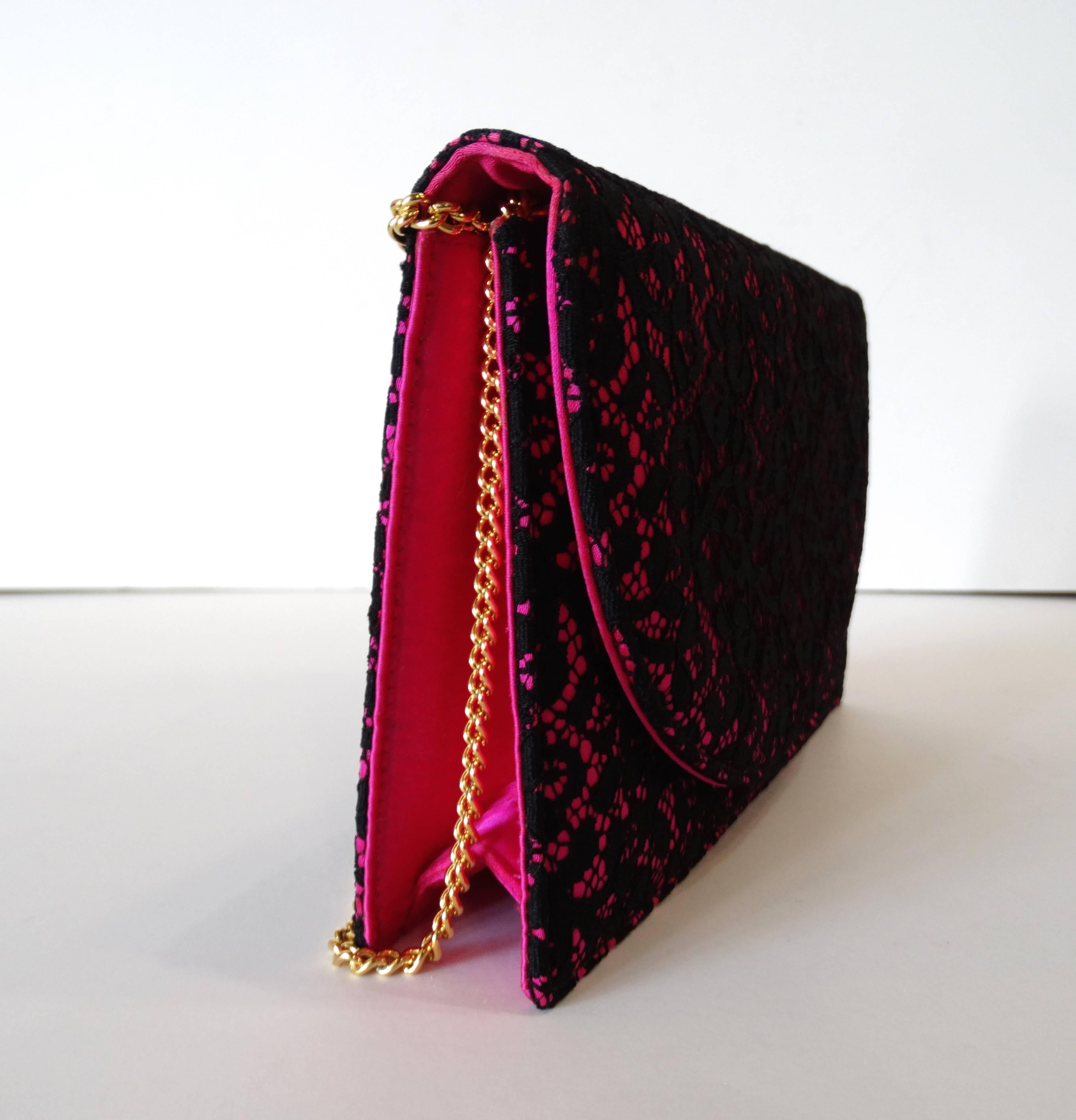 A fun 1990's Christian Dior Pink & Black  Shoulder Bag with Gold Chain. 3 ways to wear this gem! Bright pink satin with black lace floral pattern evening bag. It has flap with snap button closure and long gold tone color chain strap. Interior is