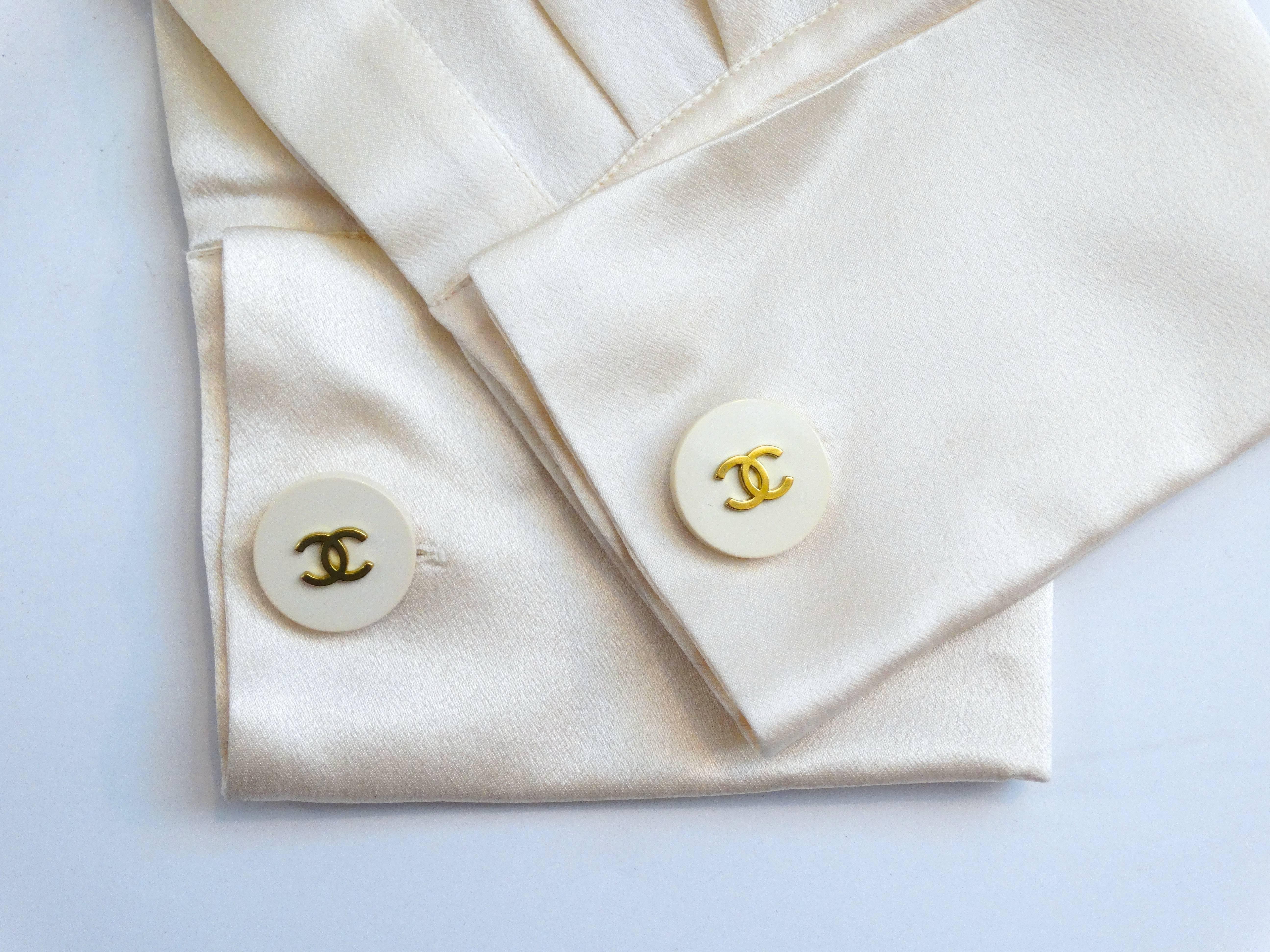 Classic 1990's Chanel Cufflinks -Cream and gold metal cufflinks; double-sided with two round disks of cream resign with the iconic Chanel double 