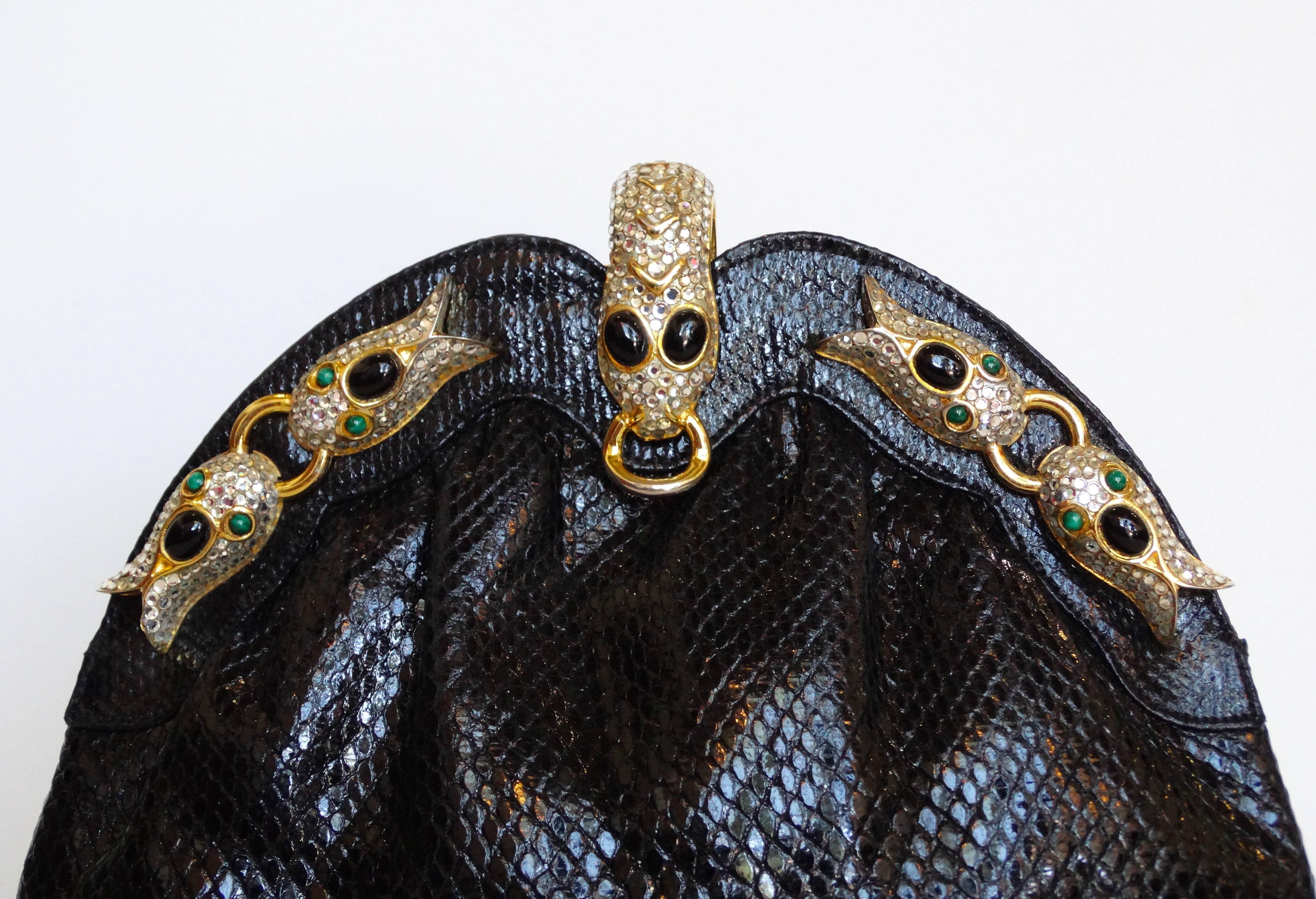 Beautiful 1980s evening bag from French designer Finesse La Model. Black snakeskin accented with gold snake hardware and crystal and enamel details. Converts to a cross-body bag with delicate gold strap which comfortably tucks into the interior.