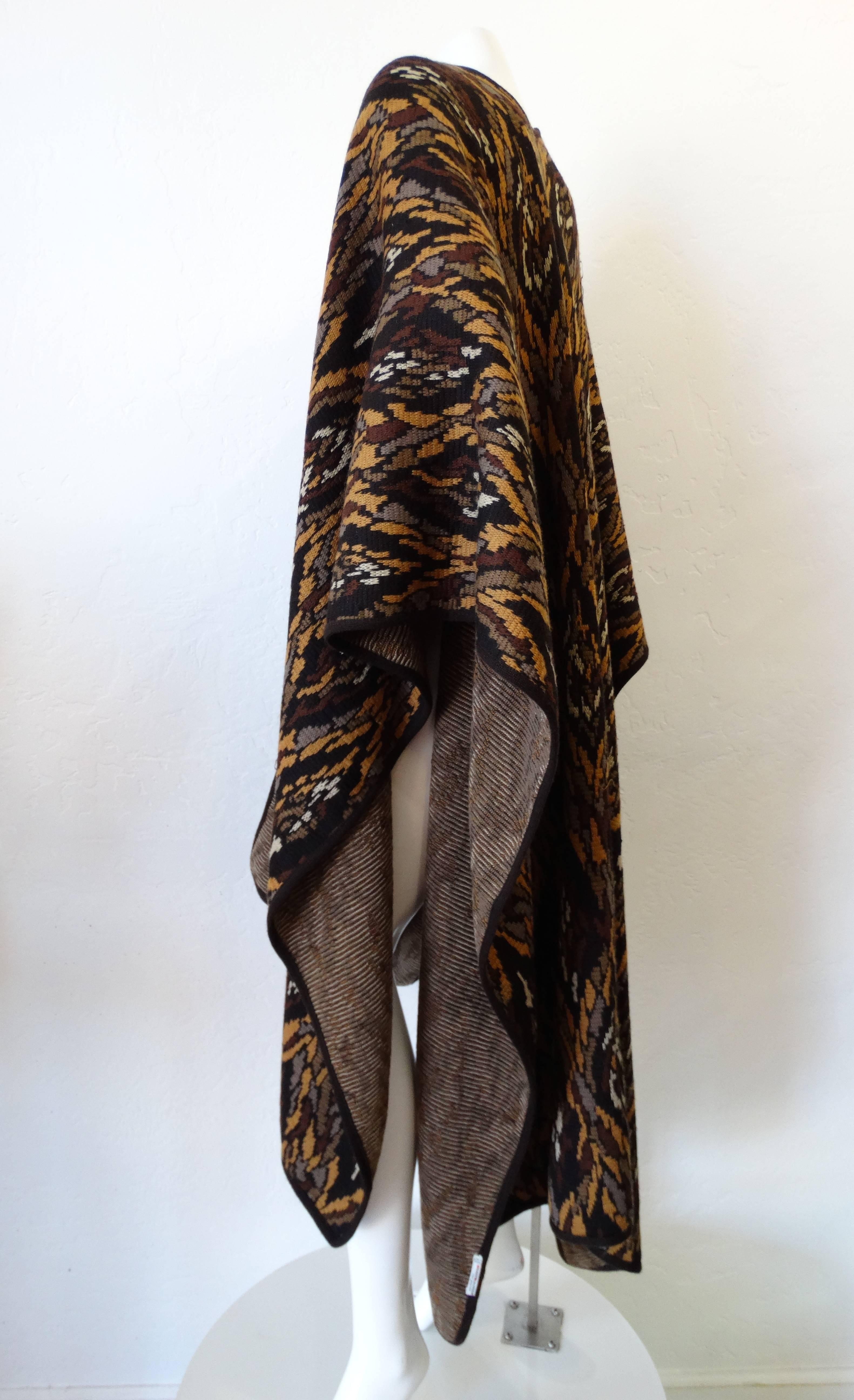 Stunning 1980s Saint Laurent blanket poncho from the Rive Gauche line! Thick woven knit in a feather like pattern- in shades of black, brown and tan. Wraps around the body, sitting perfectly at the shoulders and hangs open at the front. Would look