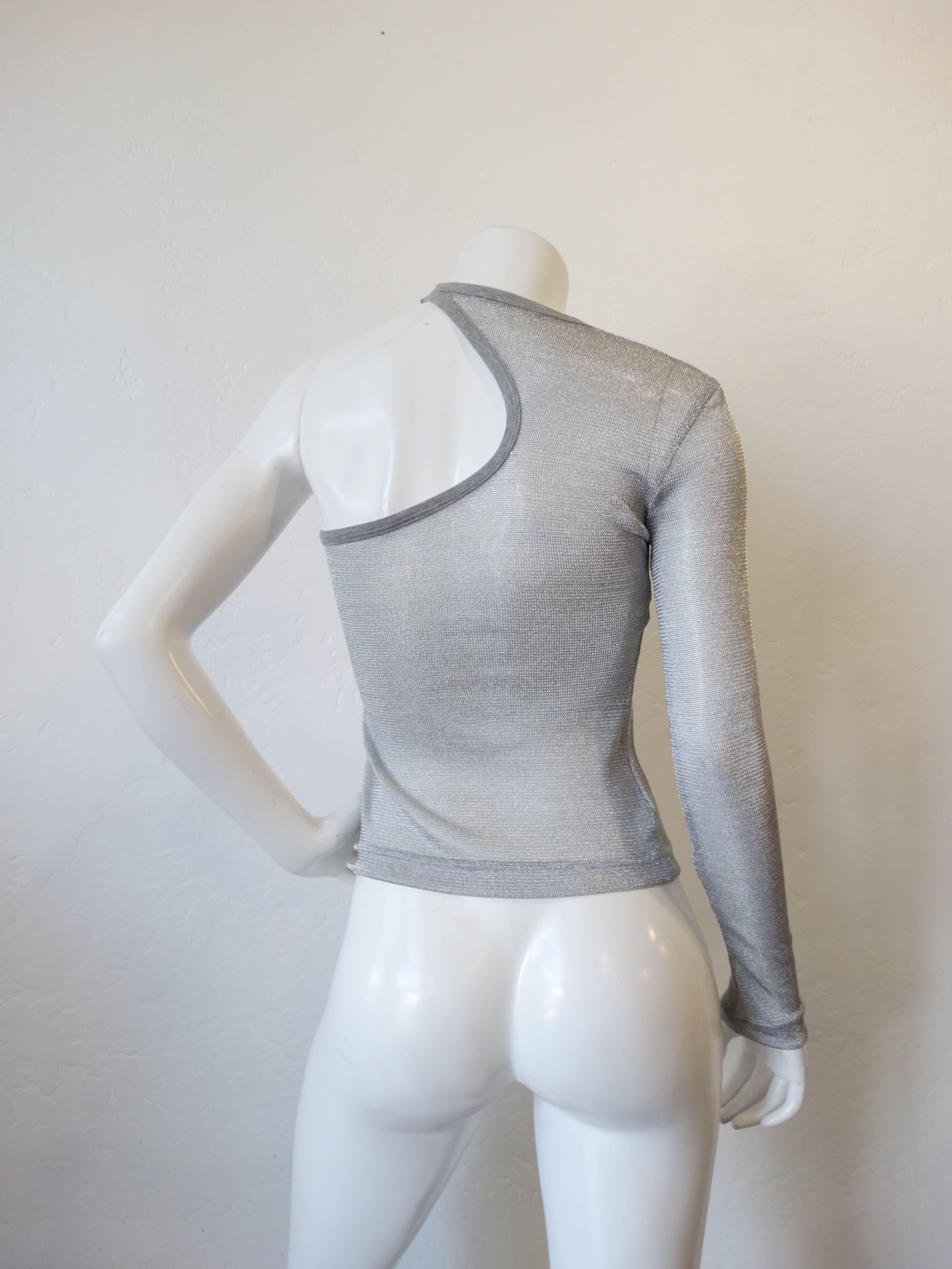 A fabulous mesh long sleeve one shoulder top with cut out, in metallic silver. Designer D&G circa 1990's marked a size 38 
