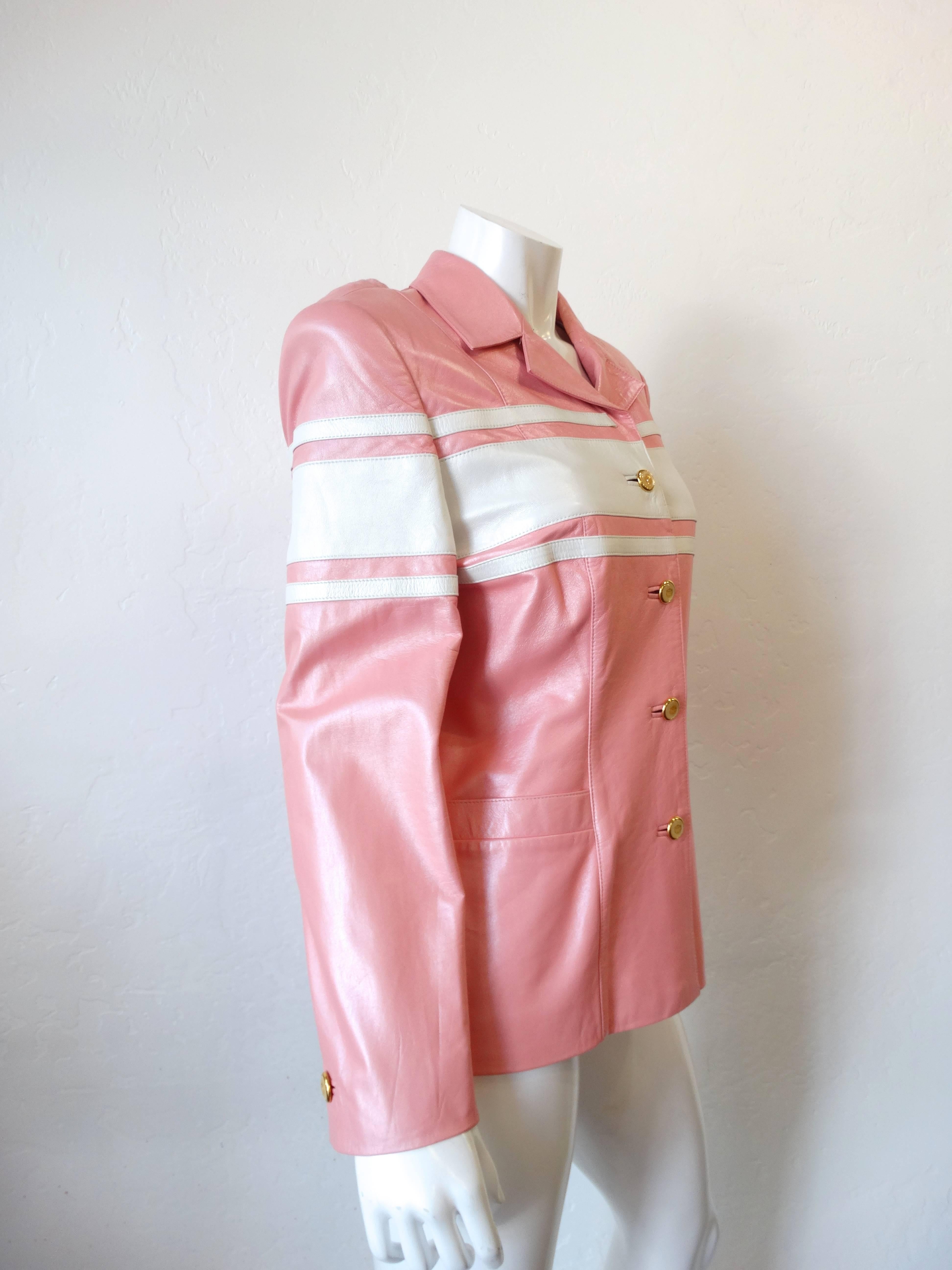 1980s Escada racing stripe jacket! Made of soft baby pink leather accented with white racing stripes. Gold metal and enamel emblem buttons up the front. Fully lined satin interior with kiss mark print! Marked a size 40. 