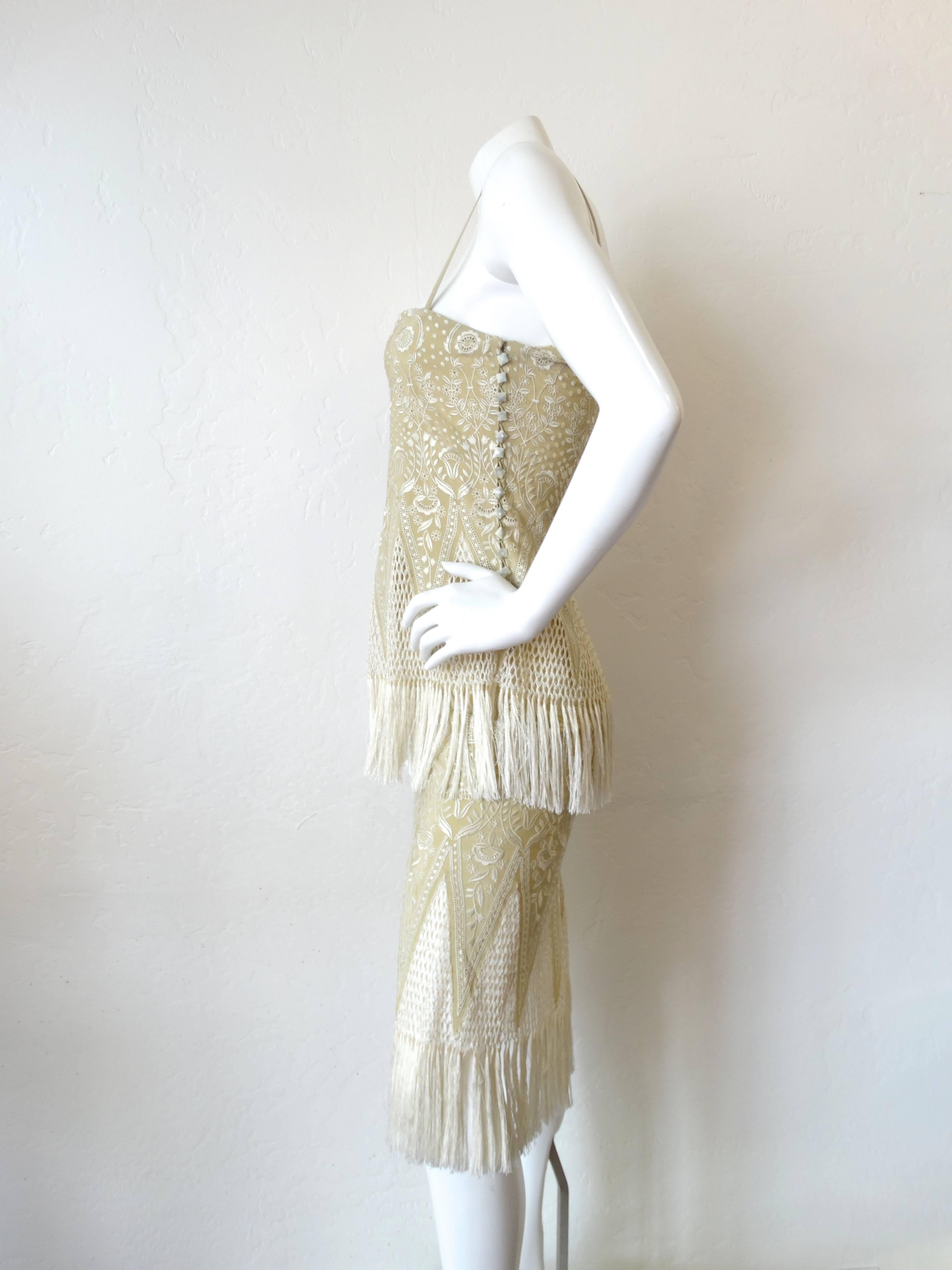 Straight from the 1970s- this Chloe piece is Karl Lagerfeld era goodness! Incredible be-fringed tank with dainty spaghetti straps. Faint tan color with creamy botanical embroidery. Waist is slightly see through with the open weave crochet pattern.