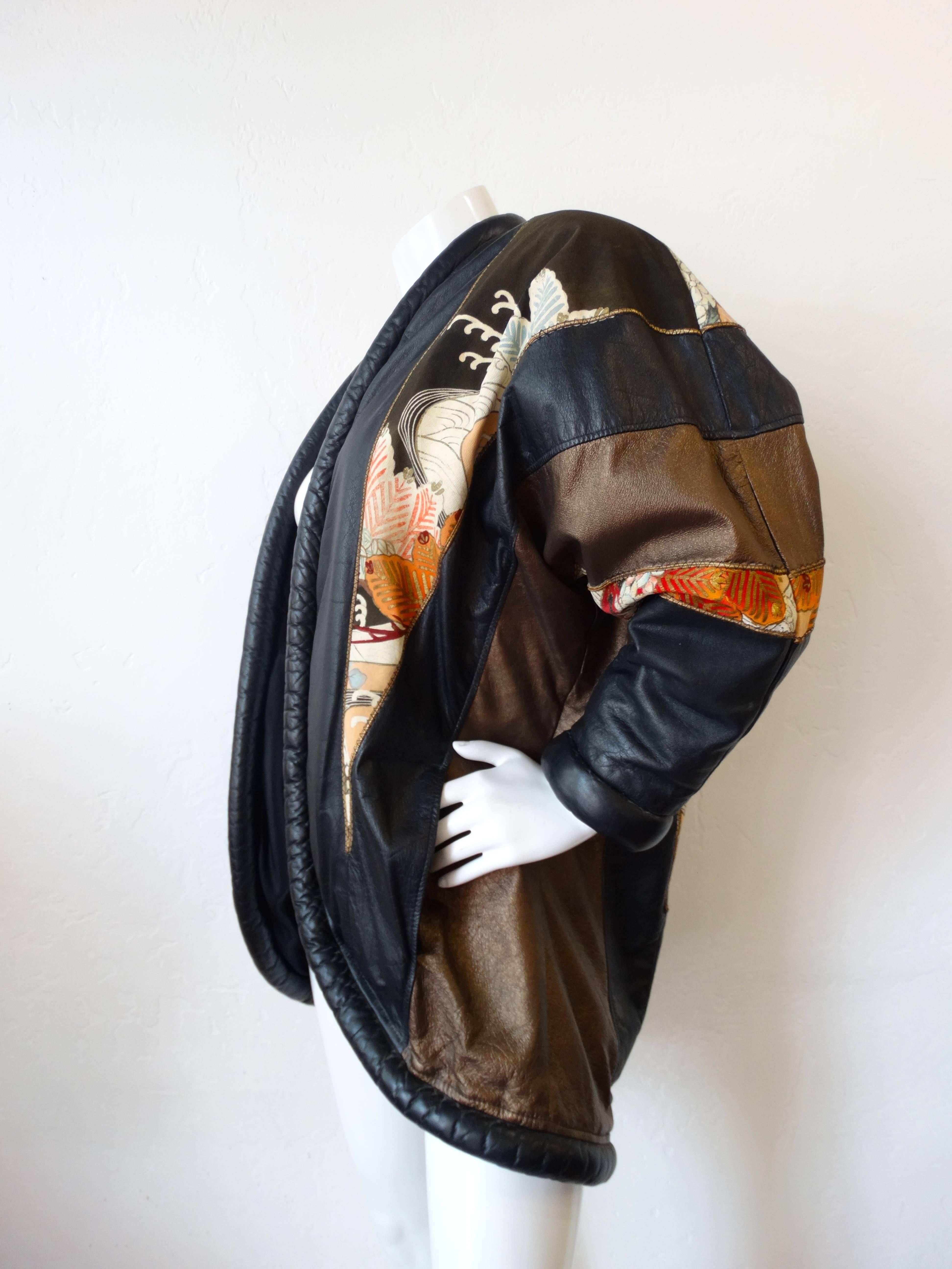 Amazing 1980s oversized leather jacket! Patches of Japanese Kimono Silk sewn into soft black and brown leather. Rolled leather edges. Shoulder pads add drama to the already oversized fit. 

Shoulder: 19“
Chest: 46“ (open fit)
Length: 34“
Sleeve: 21“
