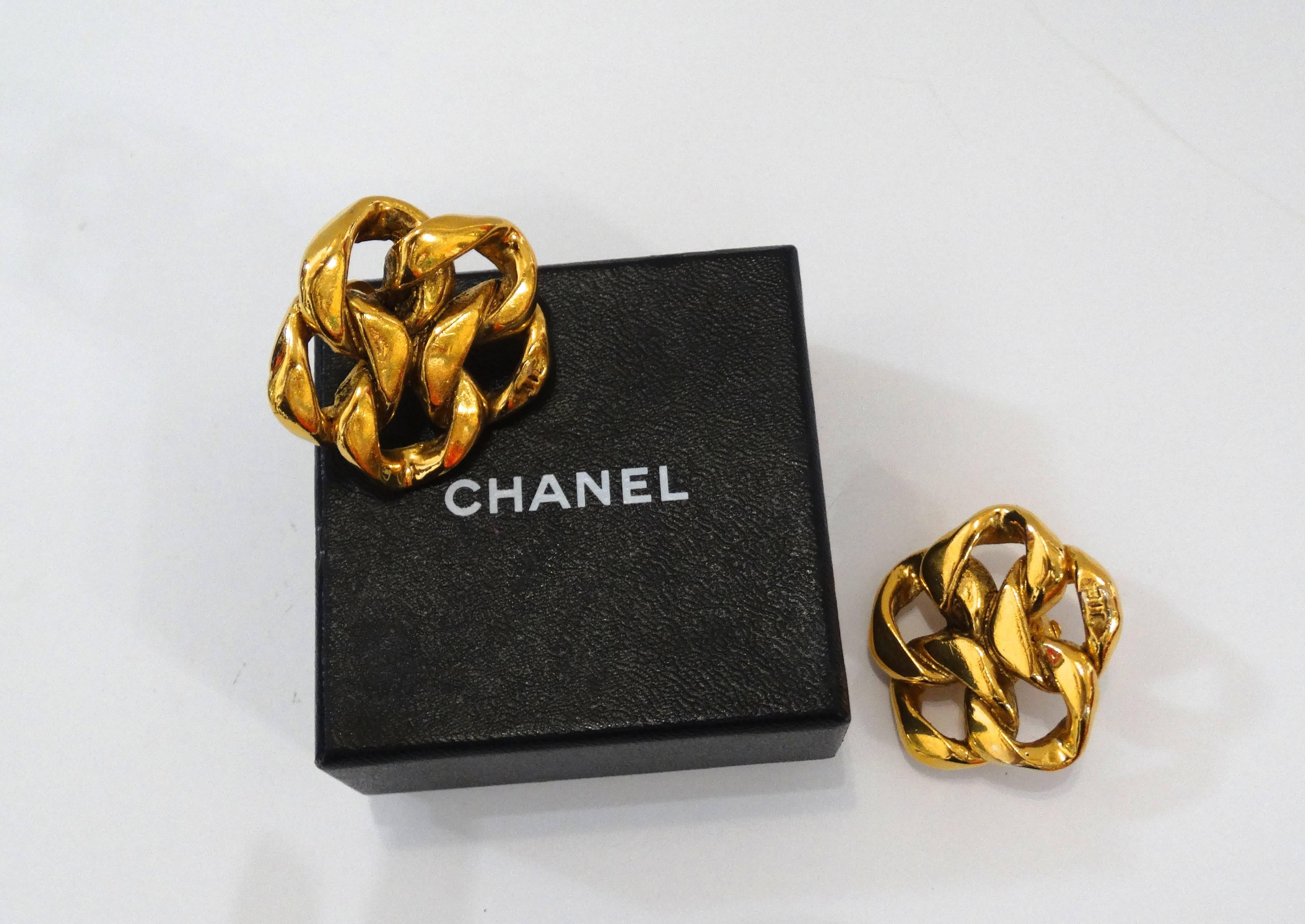Make a statement in our 1980s Chanel Chain earrings! Thick gold chain link arranged in a flower like silhouette. Small CC signature at the bottom of each earring. Clip on backs. Signature beneath clip fixtures. Signed Made in France Chanel 2 3