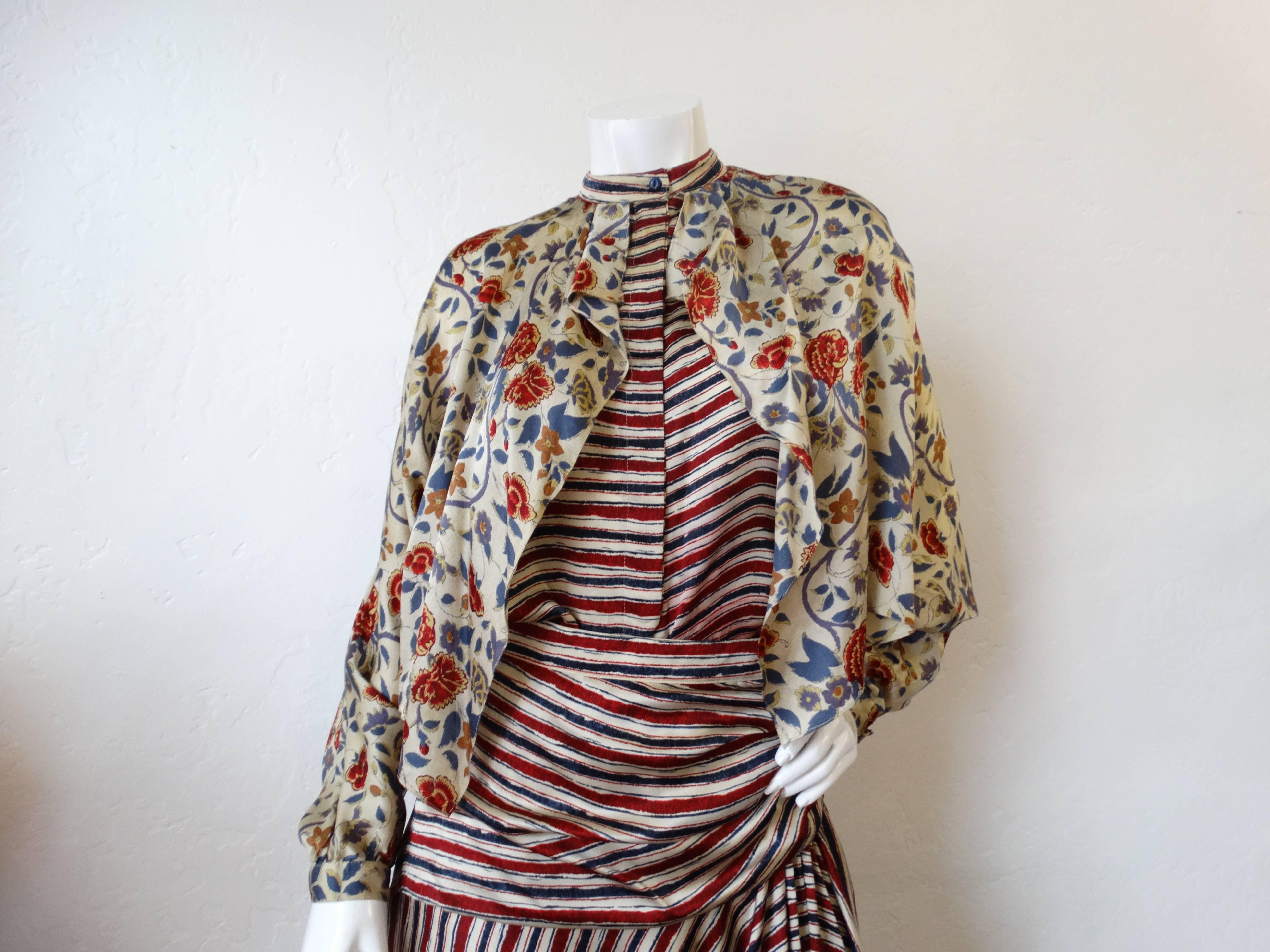 Very rare 2 piece blouse and skirt combo set from fabulous Holland designer, Fong Leng! Made of 100% silk. Printed in bold red white and blue stripe and contrasting multicolored floral print. Blouse is dolman cut, sleeves taper at the wrists.