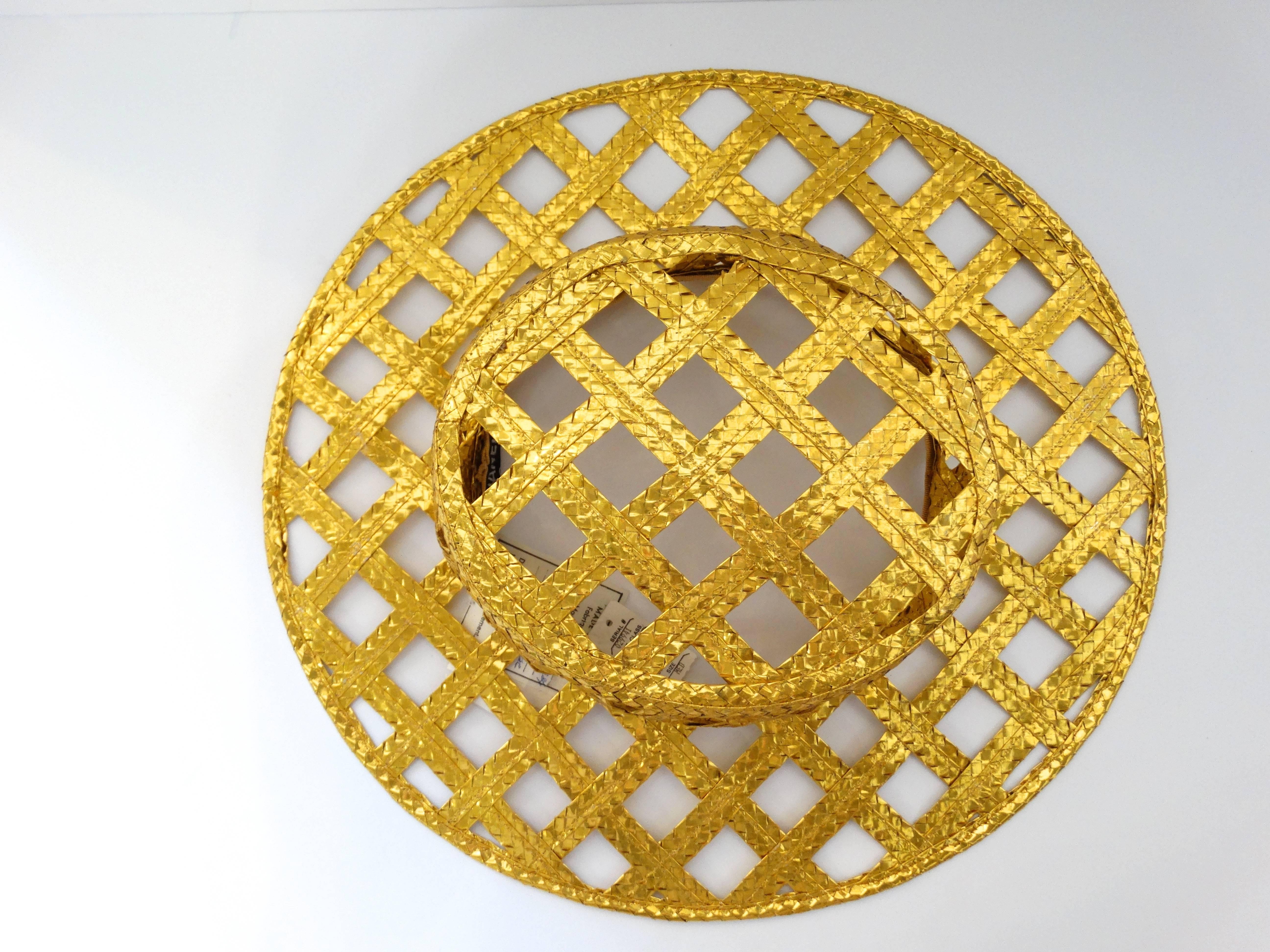 
Fabulous Chanel gold lattice hat with tags attached. This hat is gold woven and ultra shiny with a foil like effect. From Spring of 1990 this hat was originally purchased from the West Palm Beach Chanel Boutique over 27 years ago. Such a statement