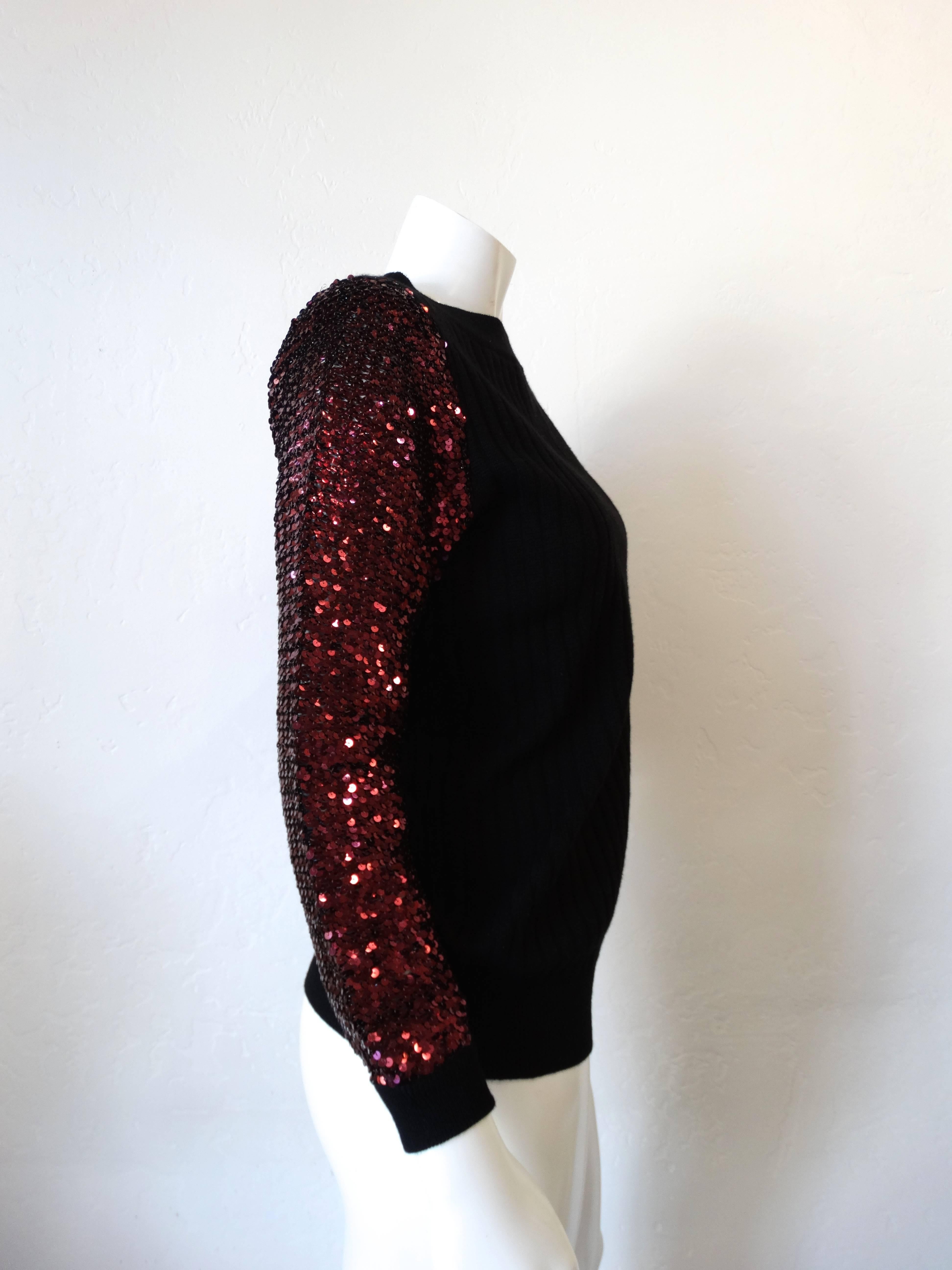 Get festive in our 1970s Saint Laurent Rive Gauche sweater! Black knit ribbed fabric with magenta sequin sleeves! Fabric has some stretch to it which allows for a number of sizes to enjoy! 


Marked a size 38
Bust: 38”
Length: 25”
Sleeve: 28” 