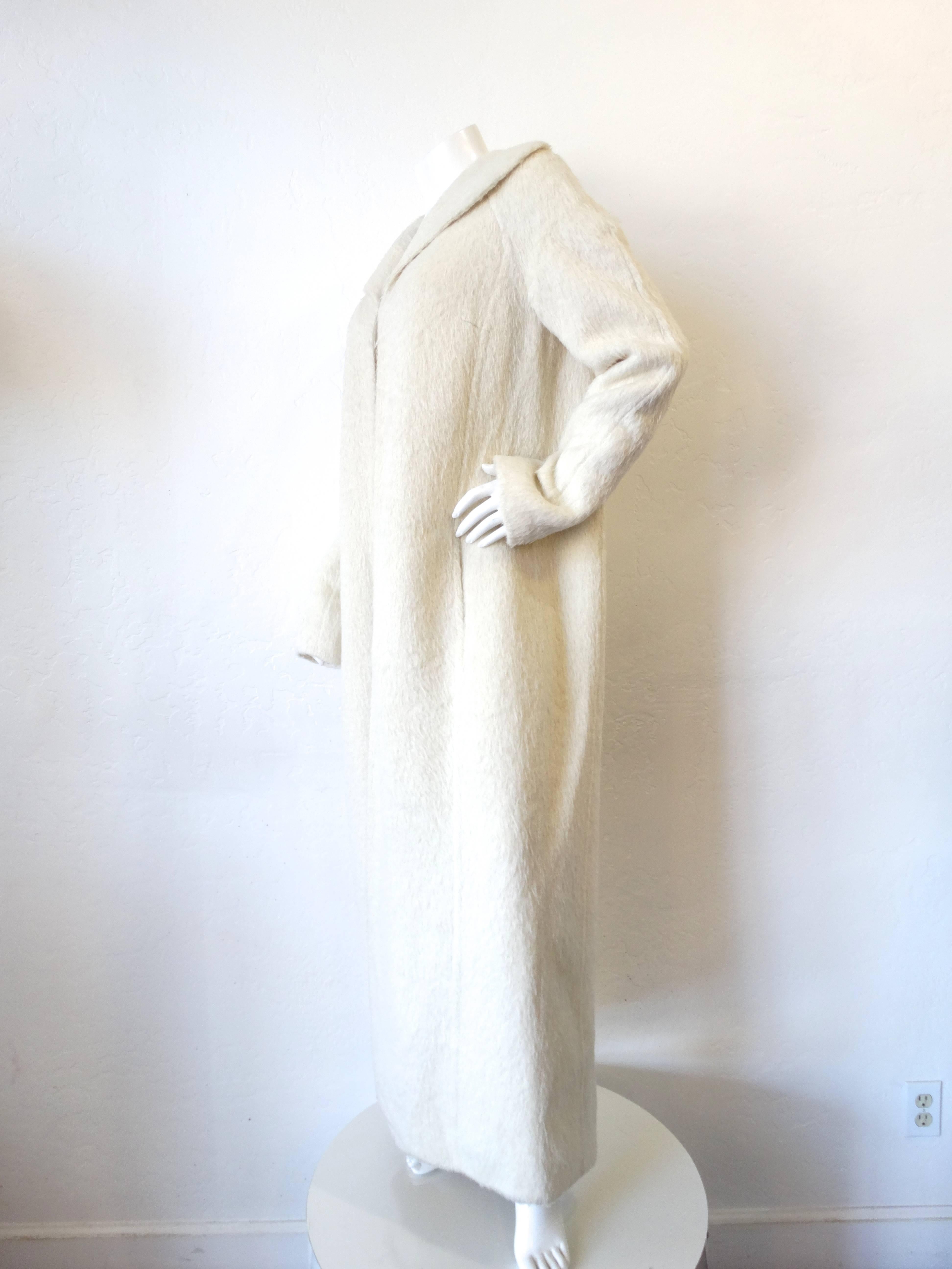 Incredible 2000s Gianfranco Ferre Runway fur coat! Long, swing coat style, has a hook and eye closure at the bust. Creamy white soft fur. Elongated arms bunch up nicely at the cuffs. All original tags intact. 

Bust: 42” 
Sleeve: 26”
Length: 56”