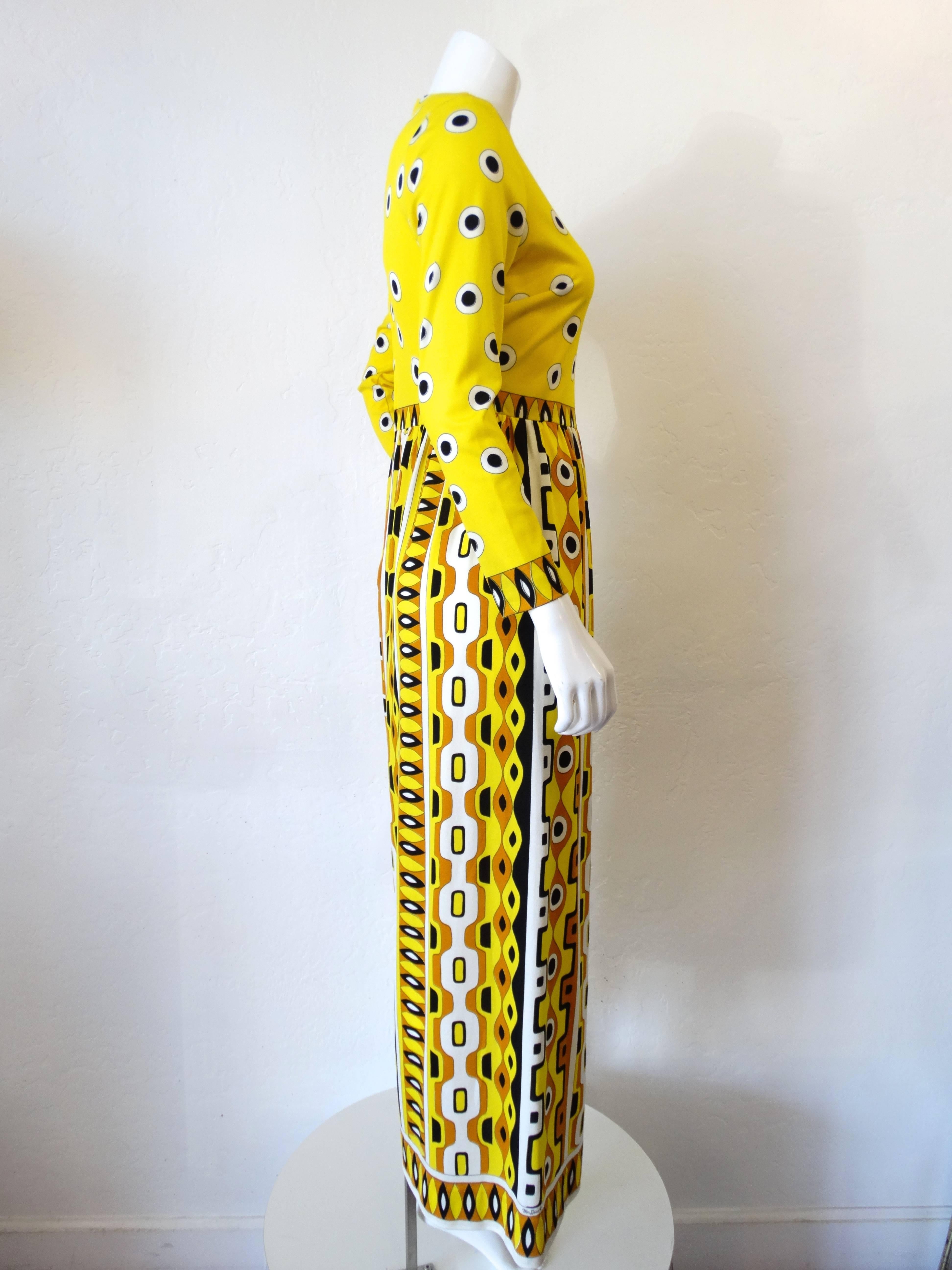 Add some color to your wardrobe with our mr. Dino  Robinson's California dress from the 1960s! Mod Bold black white and yellow dot print on the bodice with a groovy tribal print on the bottom. Flattering empire waistline. Zips up the back. 

Bust: