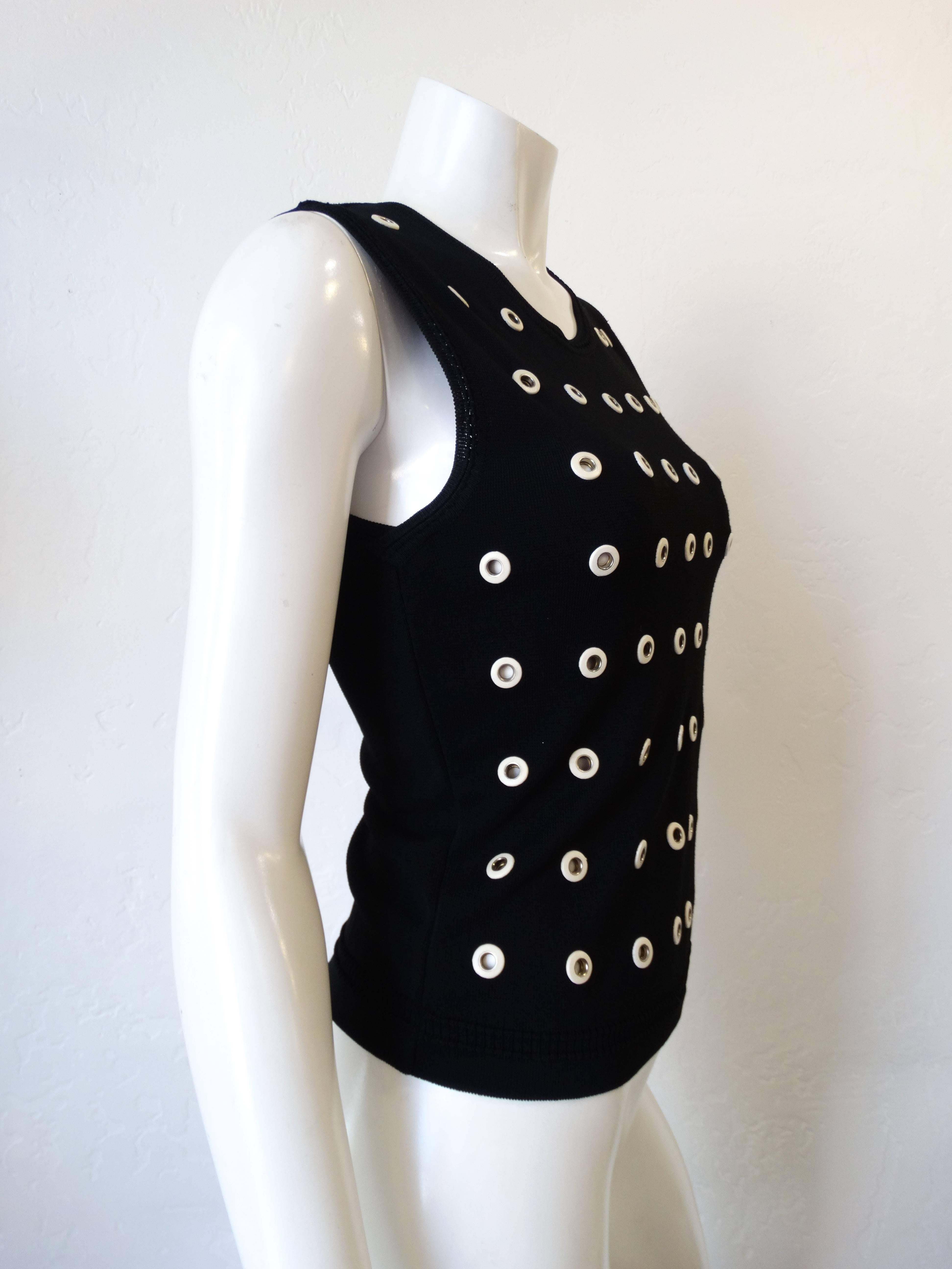 Eyelet tank from Gianfranco Ferre! This mod little tank top makes for an incredible basic- tucked into skirts, jeans you name it! Black knit fabric accented with white leather eyelets all over! Marked a size 44, best fits a size small. 

Bust: