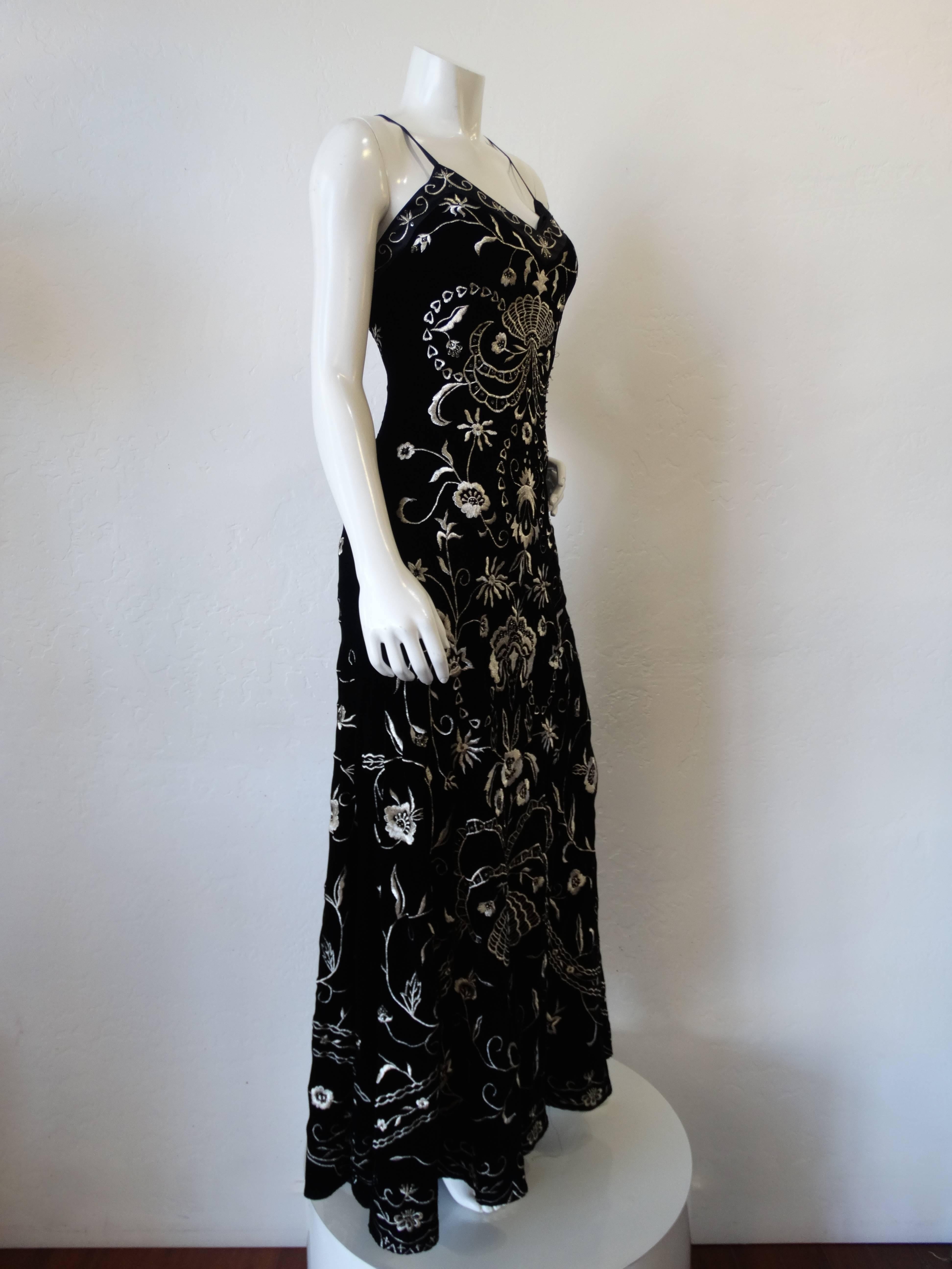 Incredible 1990s velvet dress from Sue Wong Nocturne! Slinky black velvet embroidered with silver botanical designs and beaded accents. V neckline with satin spaghetti straps. Supermodel length, goes right down to the shoes! Zips up the side.