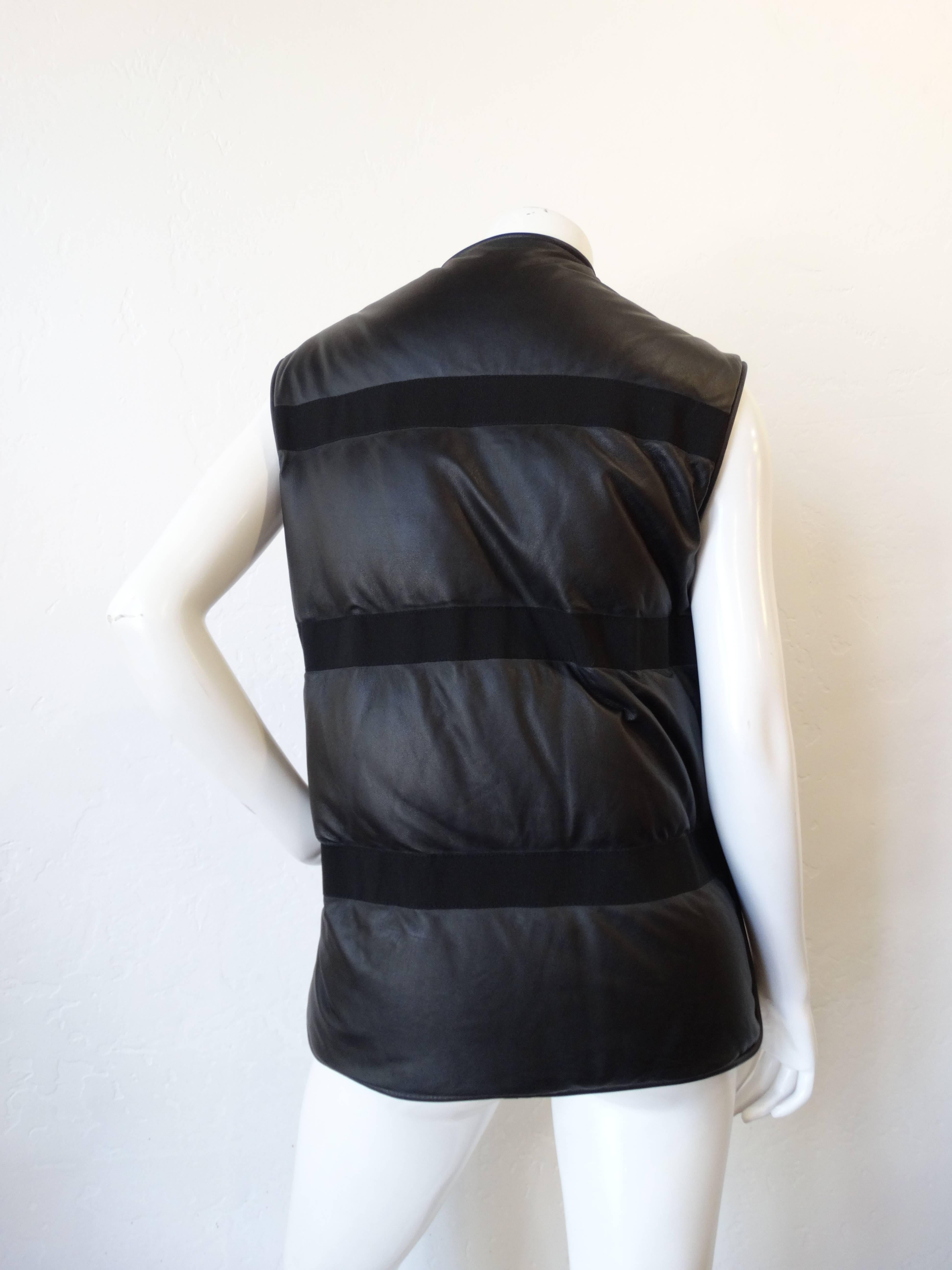 A wonderful piece from Damir Doma. A python-lamb skin padded vest. This vest features python snake skin in beige/grey on the front and lamb skin leather on the back. Gunmetal zipper front with side panel zippers. design feature front pockets with