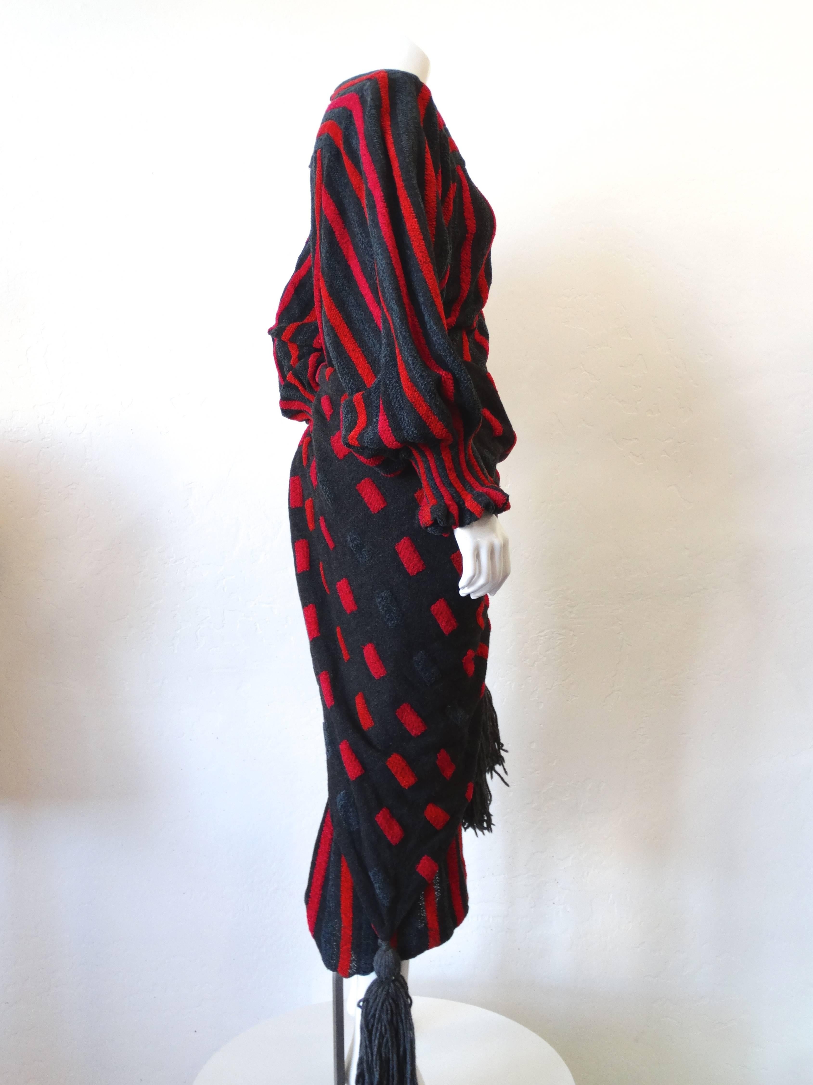 Amazing 1980s dress from Japanese-Australian designer Akira Isogawa. Sculptural balloon sleeves with elasticized cuffs. Cinches in at the waistline with matching shawl-like belt, with matching grey yarn tassels on the ends. Velour like, soft knit