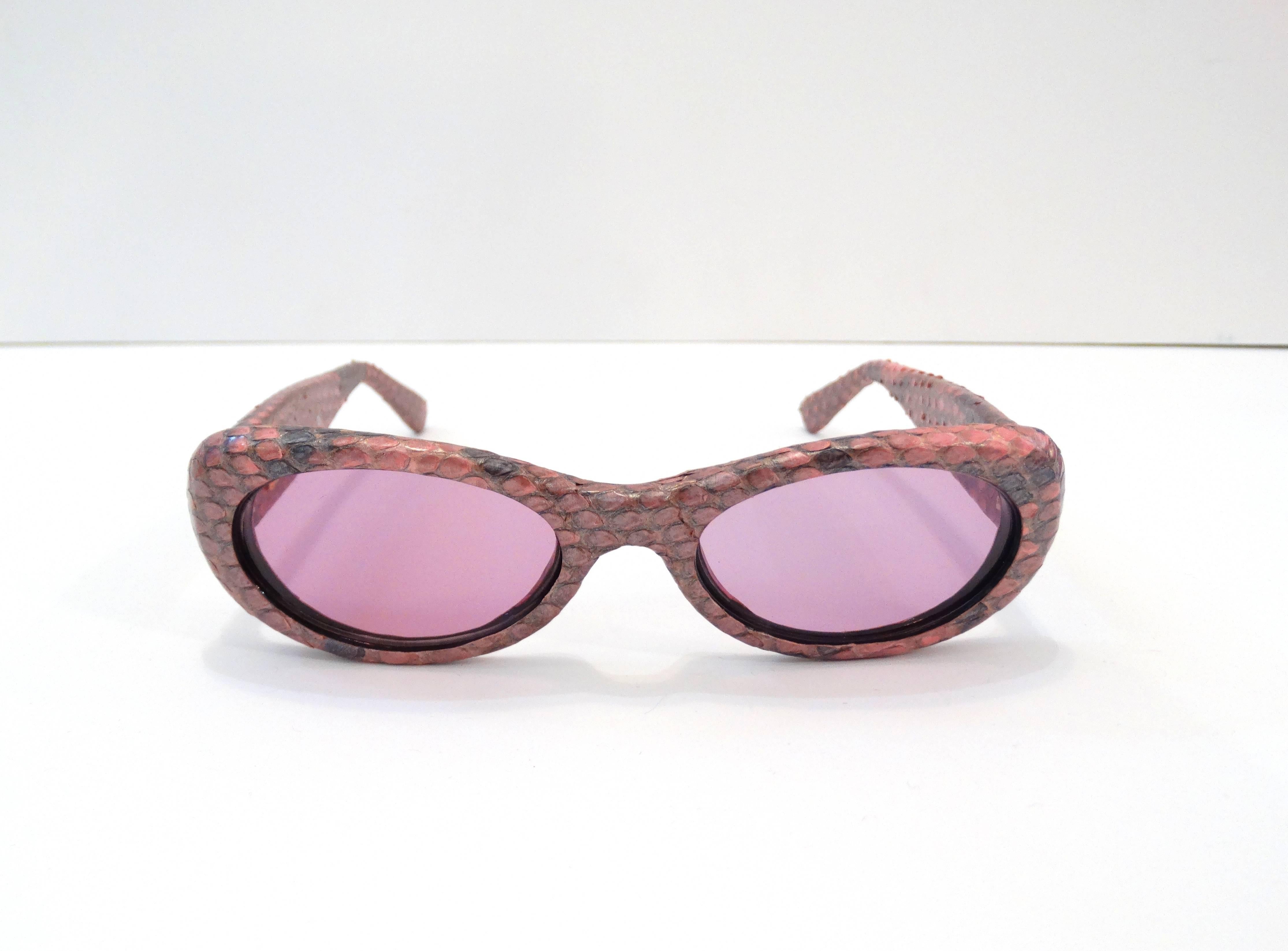 Oh so Chic 1990s snakeskin glasses from Gianni Versace! Pink and lilac faux snakeskin accented with gold stud Versace signature Greek pattern on the sides. Light pink tinted oval lenses. Gianni Versace signature on the inside of right arm with small