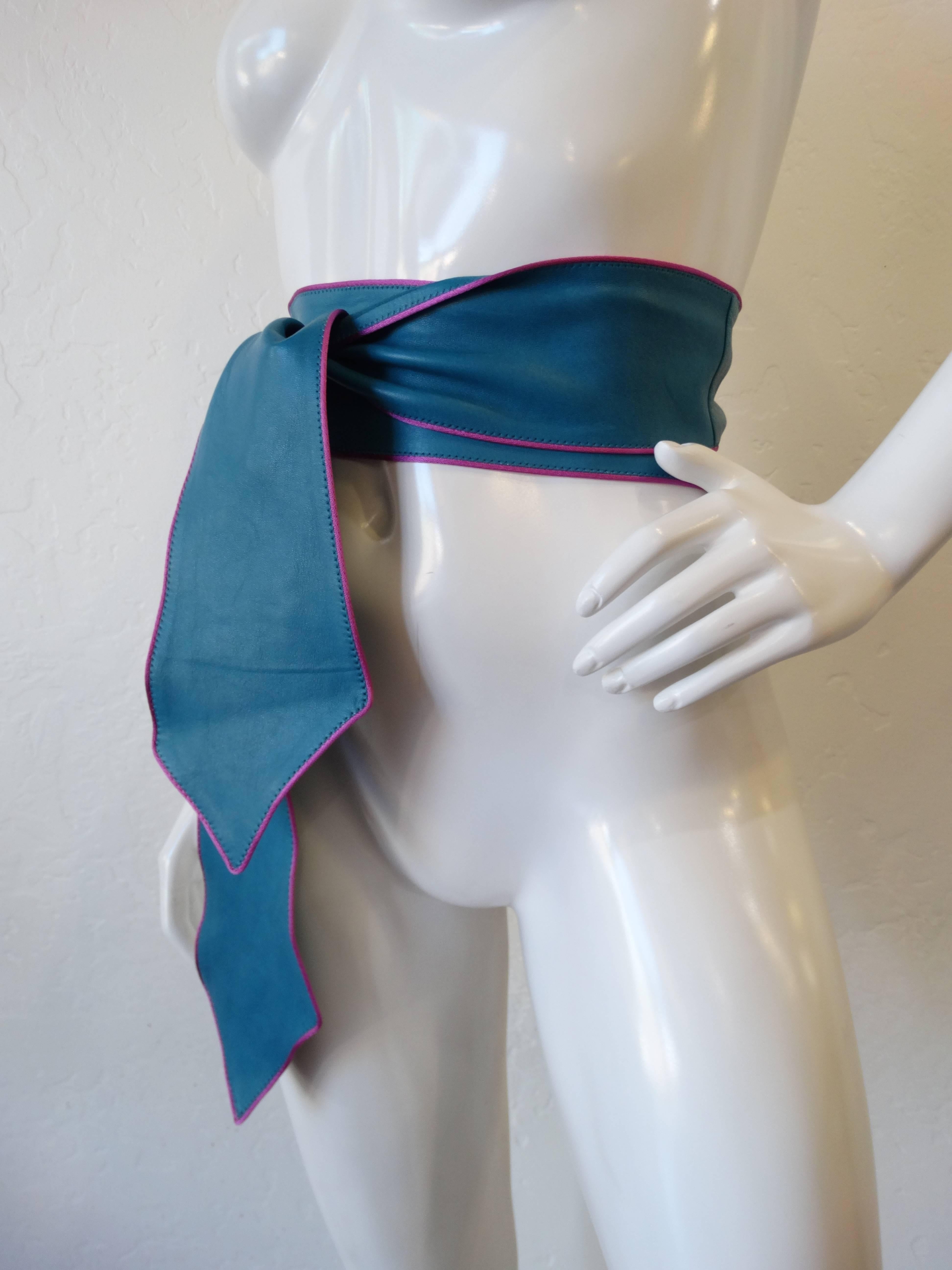 Add some color to your outfit with our blue wrap belt from iconic designer Emanuel Ungaro! Super-soft blue leather with purple cord edges. Ties up any way you like it- this piece is super versatile. 

Measures 85”; long
Width: 3.25”