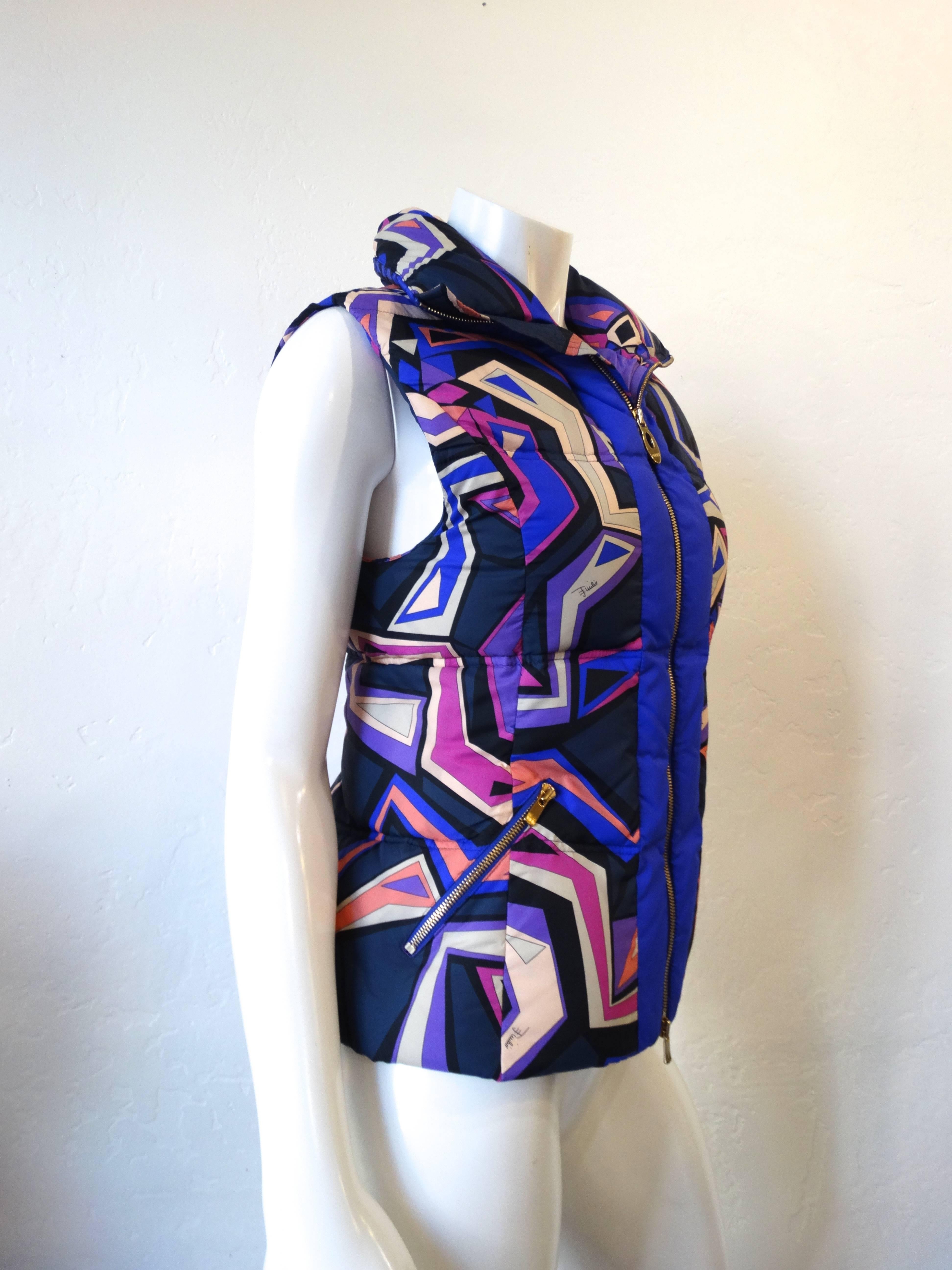 Keep warm in style with our Emilio Pucci puffer vest! Ultra violet colored fabric with multicolored geometric print all over! Zips up the front with embossed & PUCCI pull tab. Zipper pockets at either side of the waist. Can be zipped all the way up