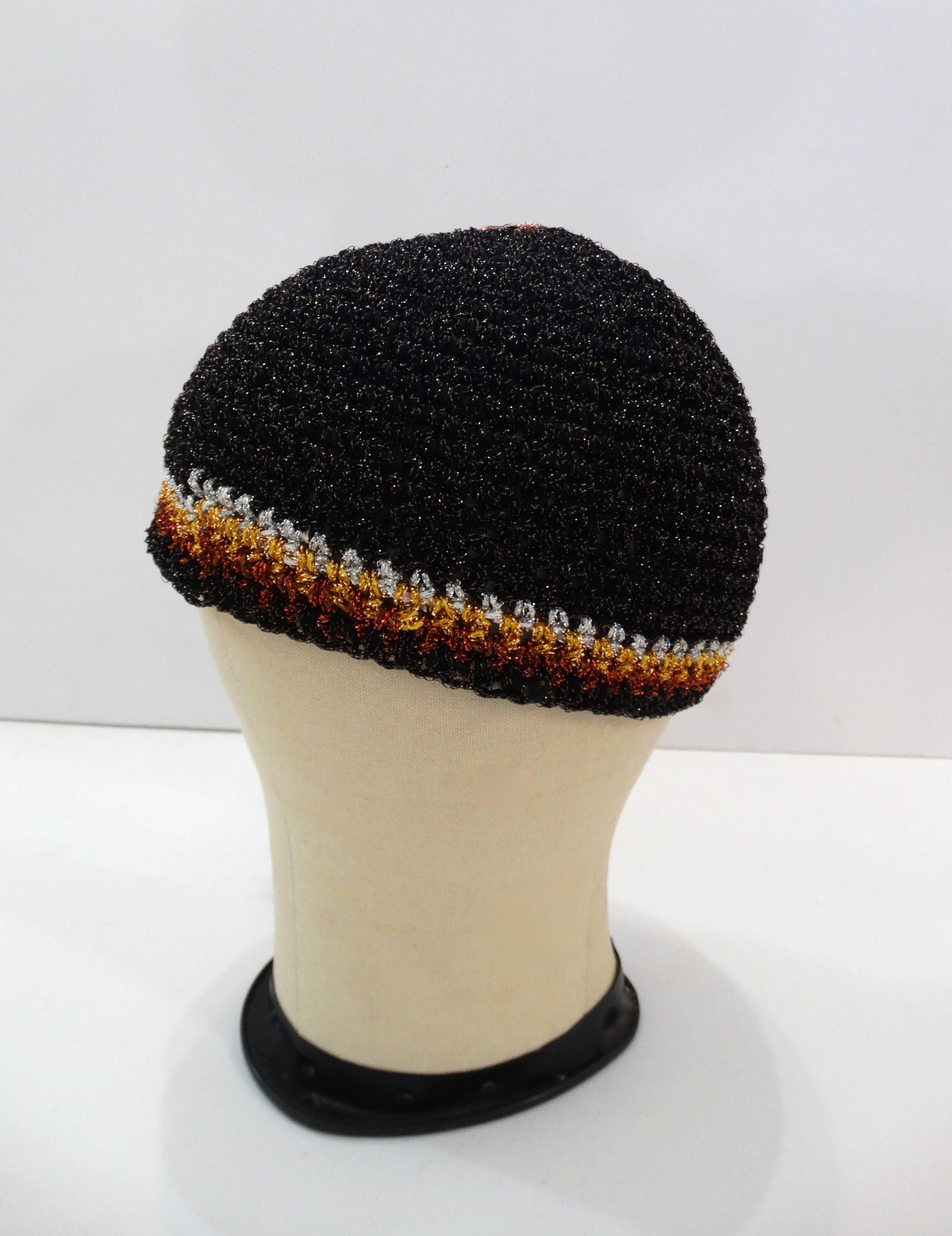 The cutest knit skullcap beanie from Saks Fifth Avenue! Metallic black, gold, silver and bronze crochet knit. Accented with braided tassel sewn down the beanie, can be worn to the side, at the back- it's really up to you! Wears comfortably at the