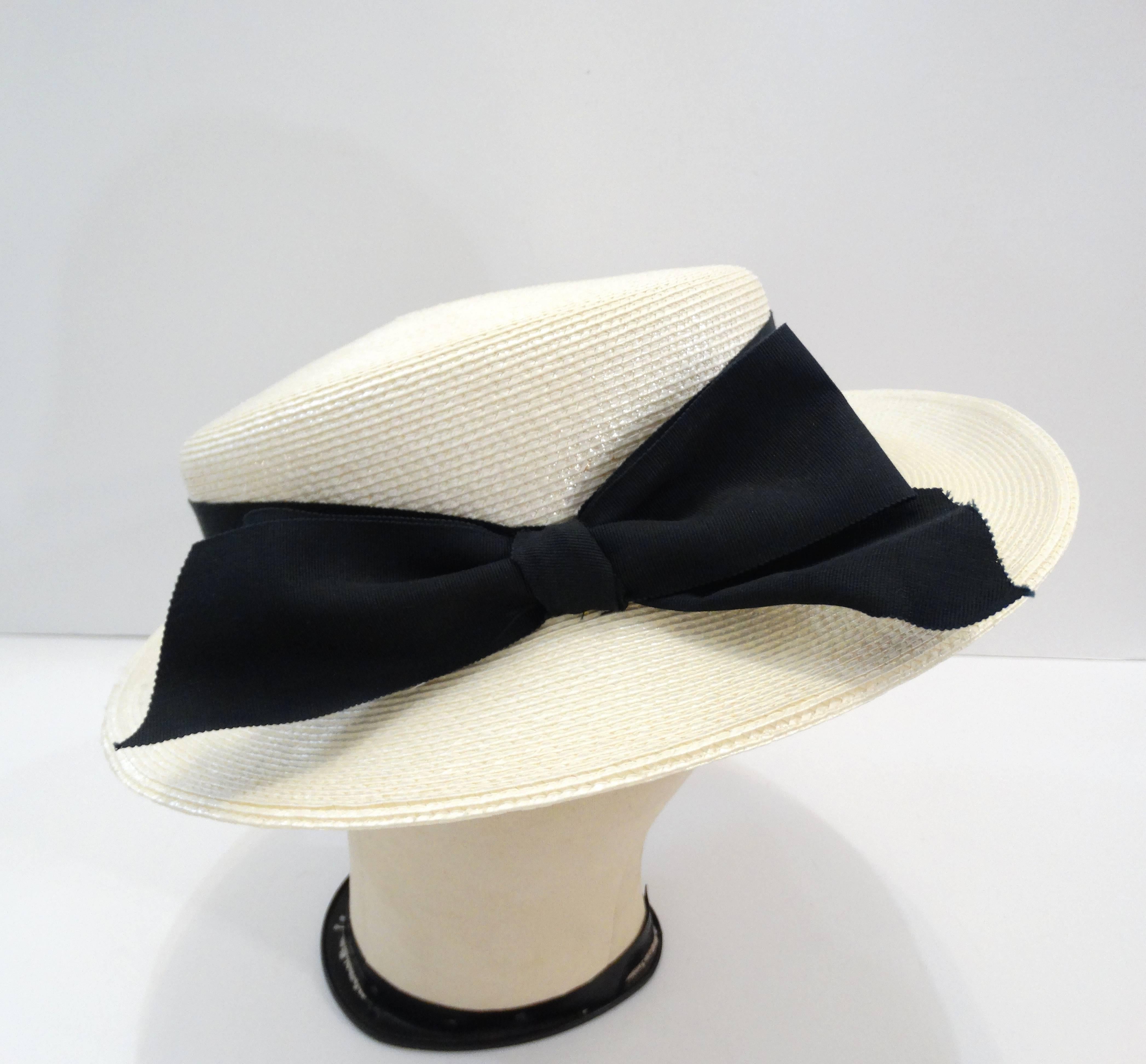 The dreamiest boater hat from prolific designer Yves Saint Laurent! Can't you just picture yourself in the French Riviera wearing this piece. Classy creamy white weave accented with thick black ribbon, tied in a bow. Sits comfortably at the back of