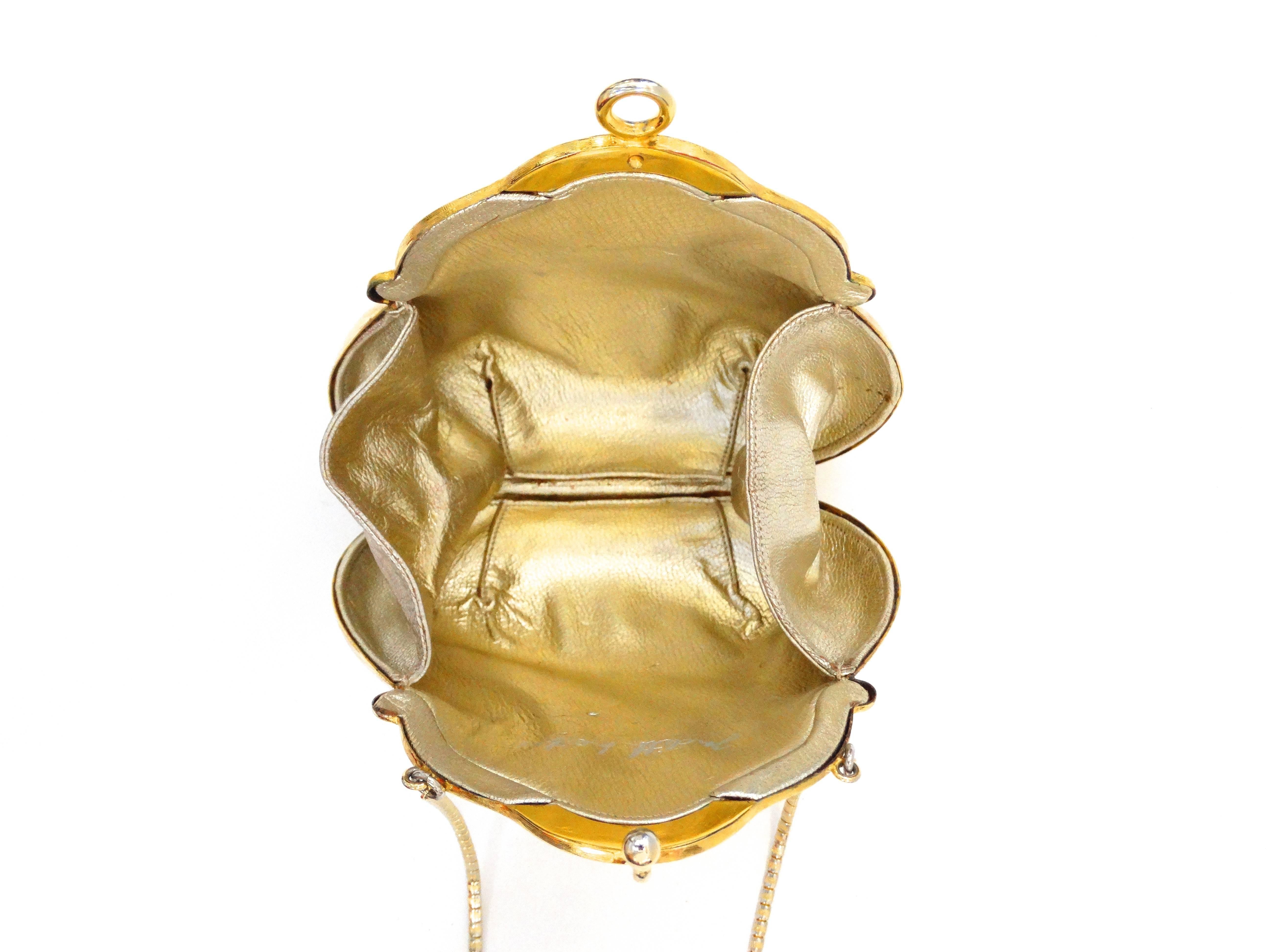 Up your evening bag game with our Judith Leiber Chatelaine purse designed 1967! Brushed gold metal in shell inspired silhouette. Shell style clasp snaps open to reveal leather lined interior. Matching thin gold strap. Signed Judith Leiber on the