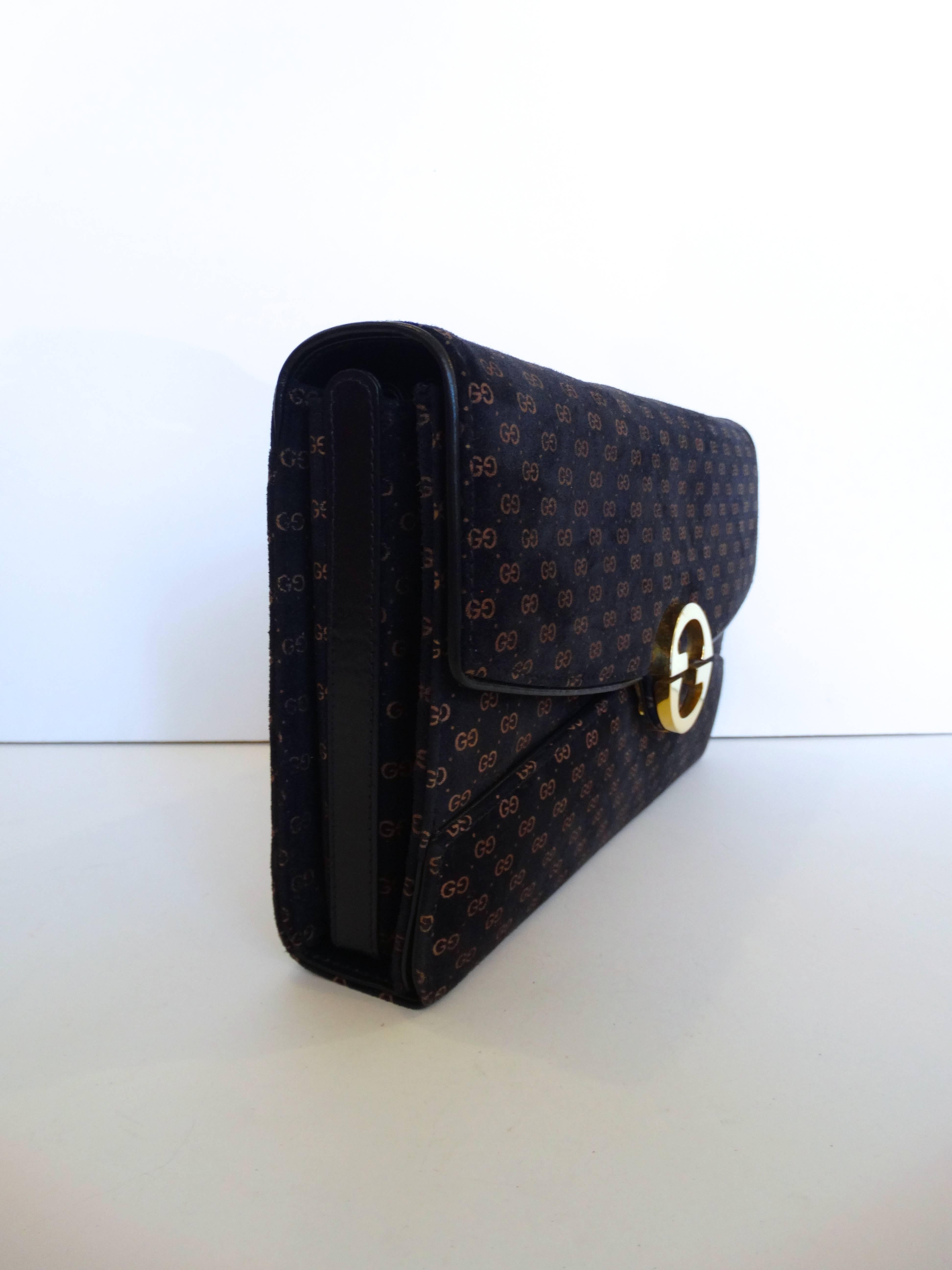 The classic Gucci monogram bag! Black and brown monogram all over print on velveteen fabric. Black leather piping and interior. “GG” gold metallic clasp- push from the top and bottom to pop open the bag. Removable strap. Unused Made in Italy 

W: