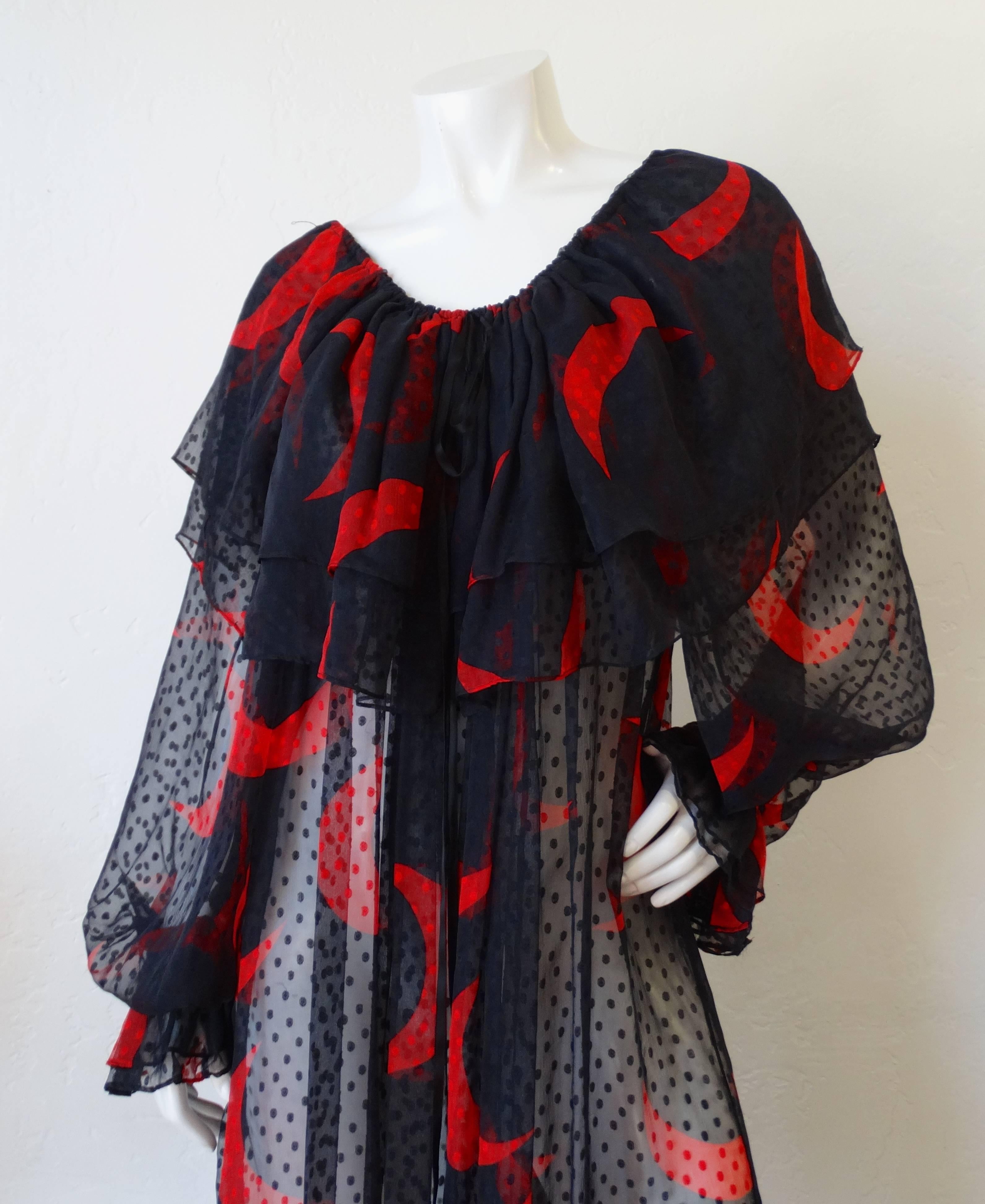 We are over the moon about this piece! This piece is by the prolific designer Saint Laurent- made in 1978! Loose, dreamy peasant style fit dress with billowing sleeves and off the shoulder fit. Ruffled, layered neckline with ruffle cinched cuffs to