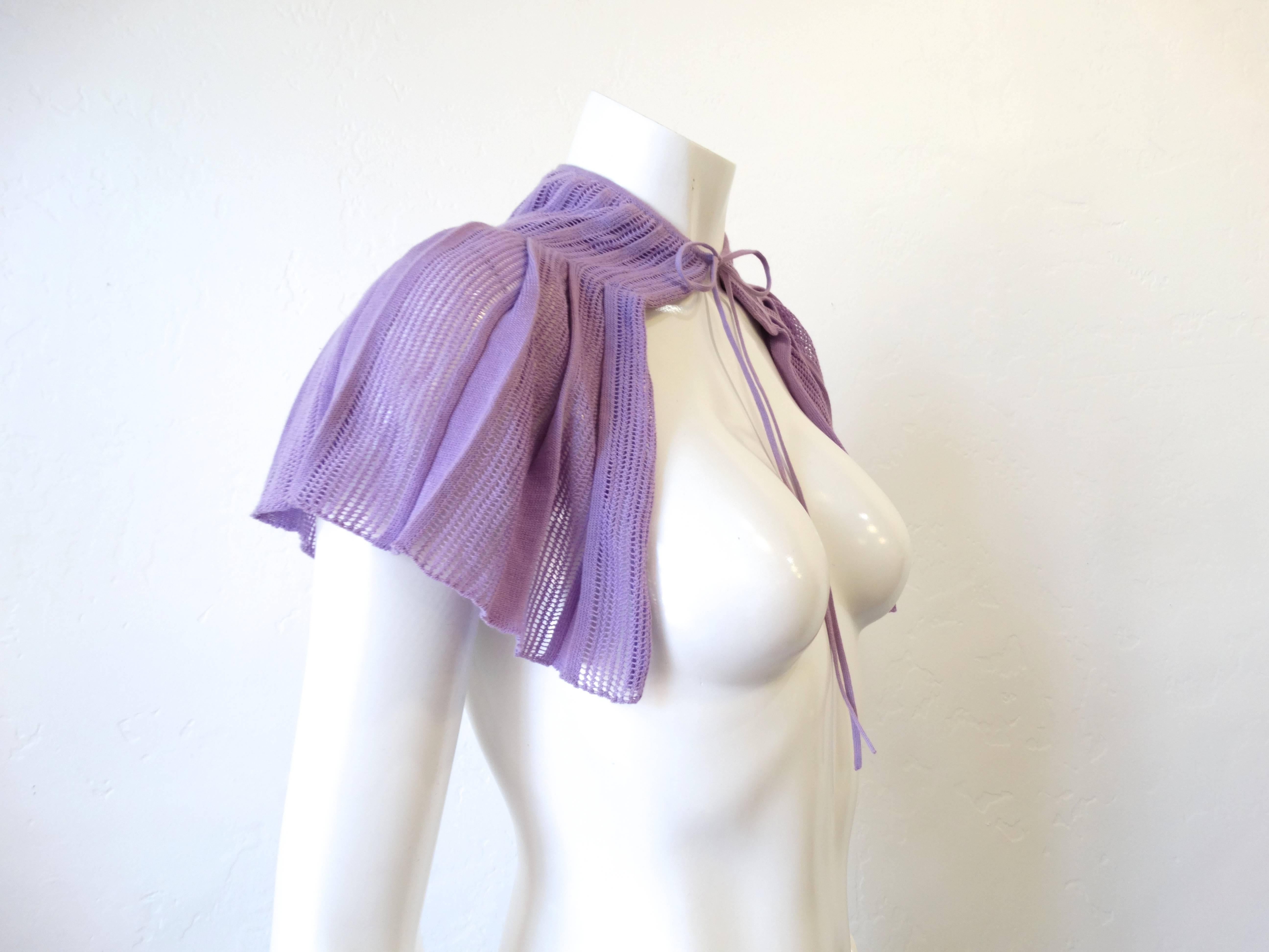 Adorable little Chanel knit capelet! Ties around the neck in a bow, lays over the shoulders perfectly. Soft lavender knit with pleated construction. Marked a size 38 though it would fit most small frames. 

Length: 12 in 