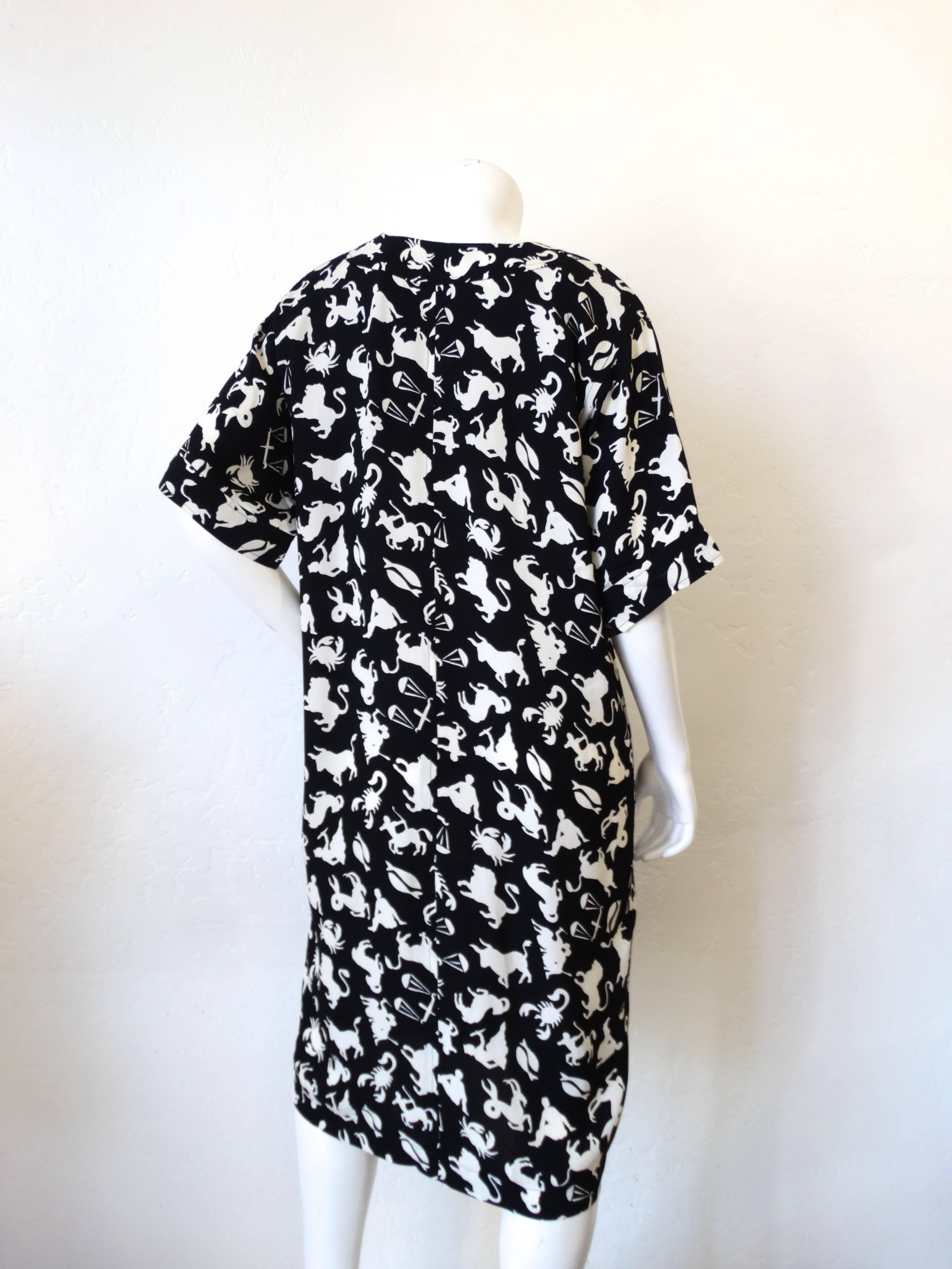 What's your sign? Whichever it is- it's on this dress! This incredible printed dress is from iconic designer Saint Laurent! Black and white astrology inspired zodiac all over print. Shift dress construction with short flowing sleeves! Looks cute