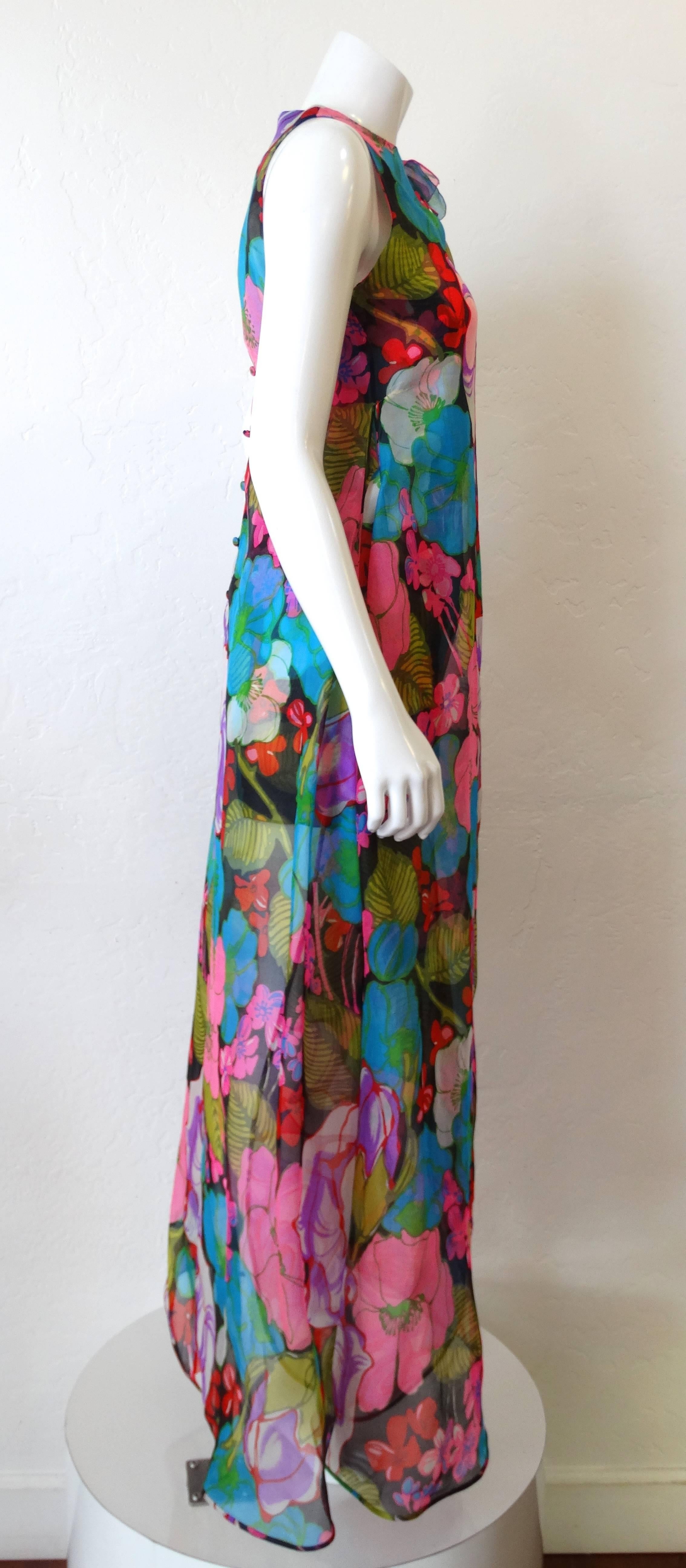 Have you ever seen a more fabulous romper? This fantastic piece is from the 1970s by Parisian designer Pierre Cardin! Fitted, sleeveless short romper with long sweeping overlay in matching fabric. Technicolor rainbow floral print on sheer flowing