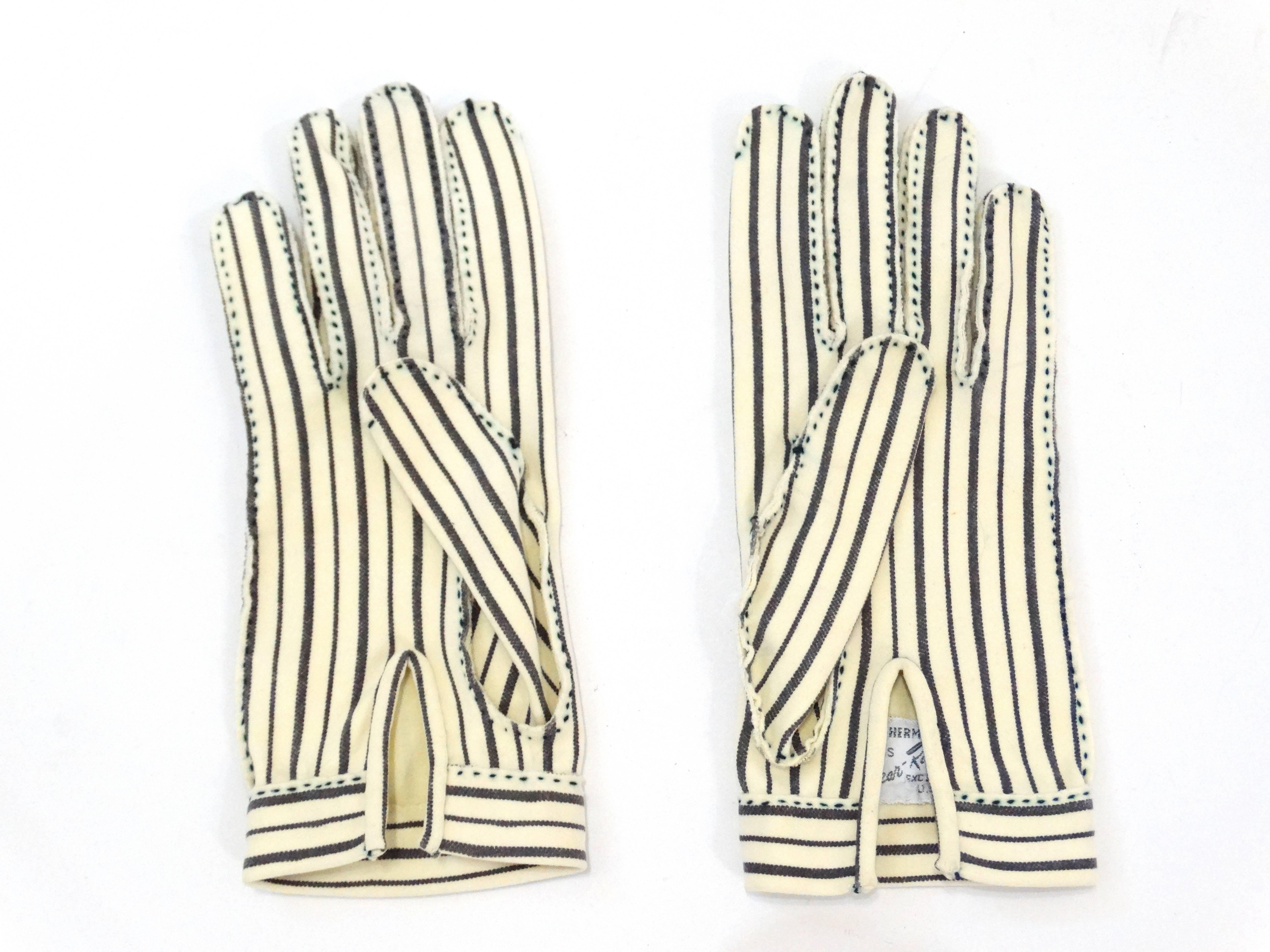 Is there anything more glamorous than a pair of driving gloves? Yes- HERMES driving gloves. Creamy white and black vertical stripes with matching heavy stitched details. Split at the wrist for easy on and off. These gloves are petite and would best