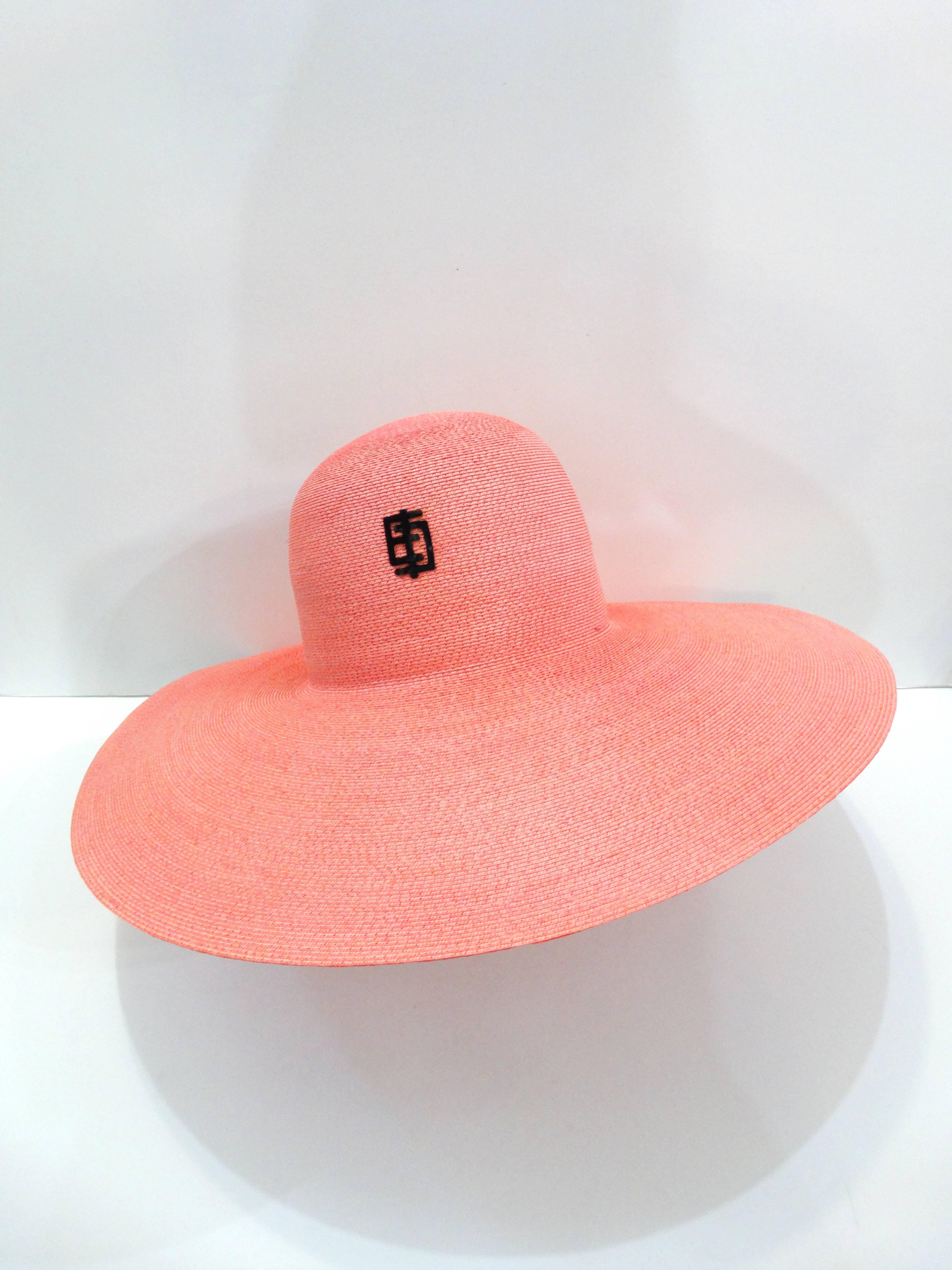 Shield yourself from the sun in style in our 1960s Emilio Pucci sunhat! Made of a quality woven straw dyed in a sunset pink color. Trendy super wide brim frames the face flawlessly- the perfect hat for a beach-y hair moment! Embellished with