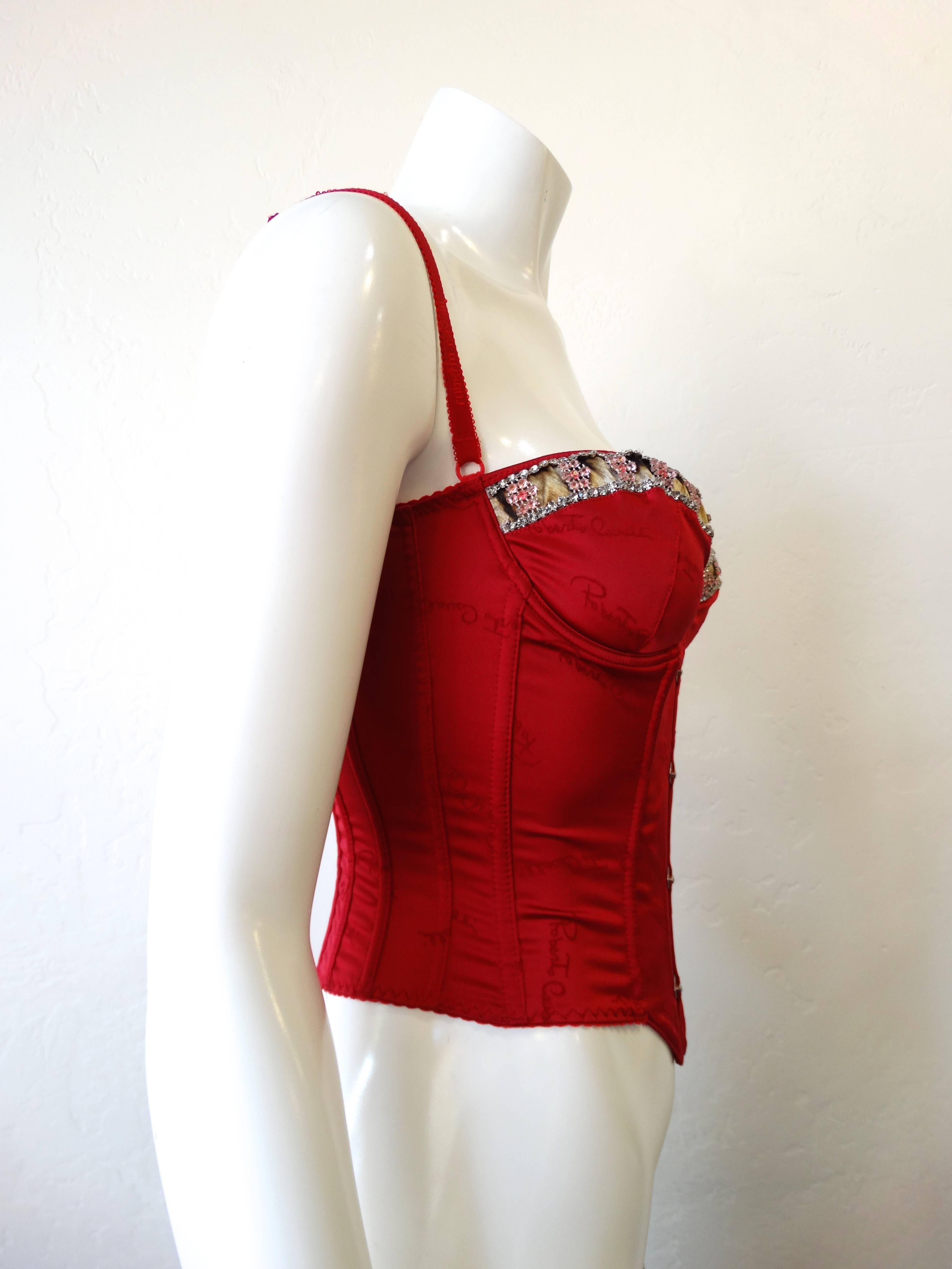 Channel your inner Moulin Rouge in our amazing Roberto Cavalli bustier! Made of a silky red stretch satin accented with leopard on the cups. Pink and clear diamante rhinestones all along the tops of the cups. Super adjustable fit, straps can adjust