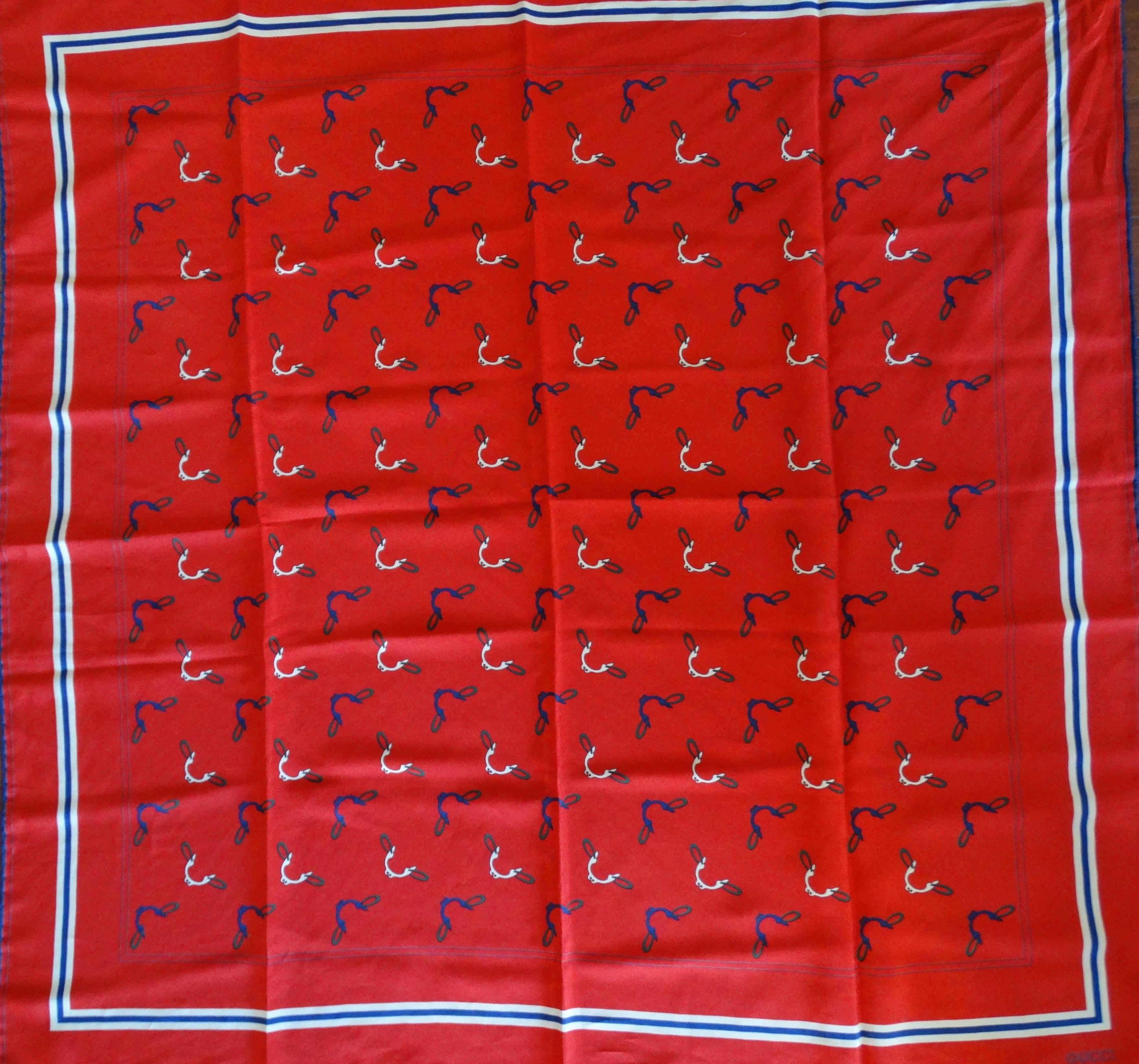 It goes without saying, this piece is a classic! Bright red vintage Gucci silk square scarf from the 1980s! Red solid base with blue, green and white horse bit print all over. This piece is so versatile- wear it as a headscarf, tied around your