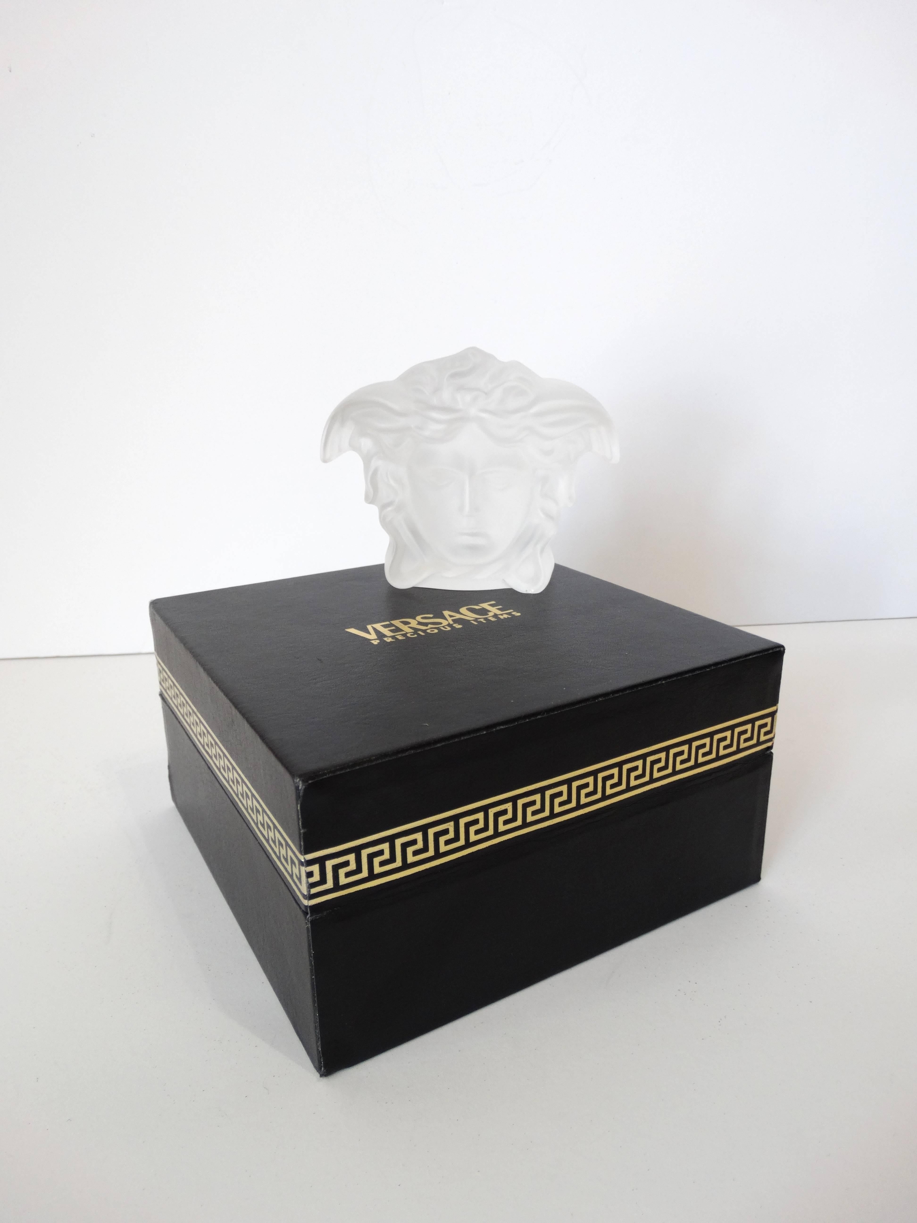 Add some vintage to your desk decor with our Versace paperweight! Classic Versace Medusa head silhouette made of a heavy semi translucent frosted glass! Made in collaboration with Rosenthal! Signed at the bottom with Rosenthal x Versace. Comes with