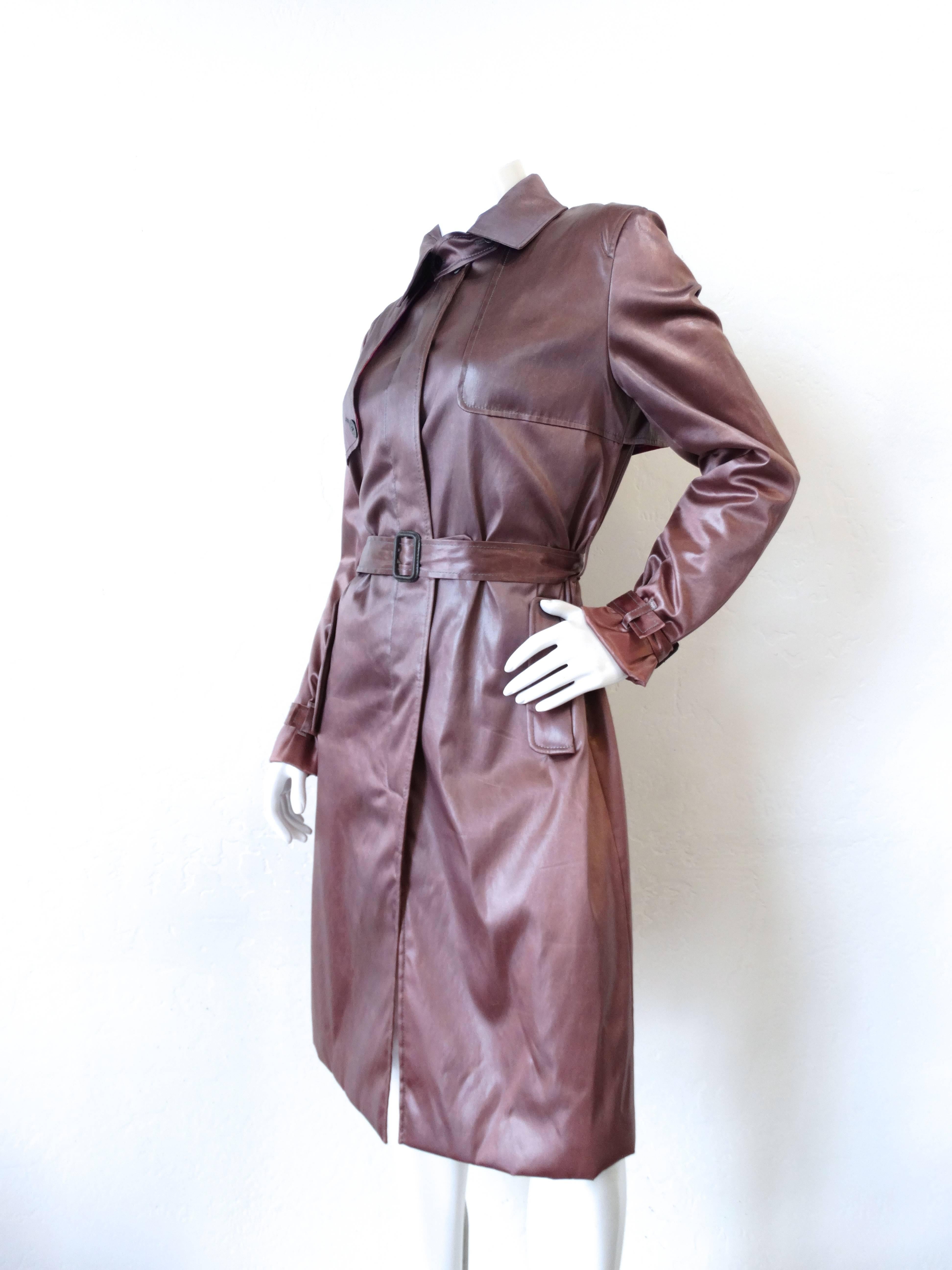 Nothing like a little bit of Pucci to liven up your outerwear collection! Super silky soft satin in this amazing dark dusty lilac color. Classic trench coat construction with a slightly cropped fit. Buttons up the front with hidden button