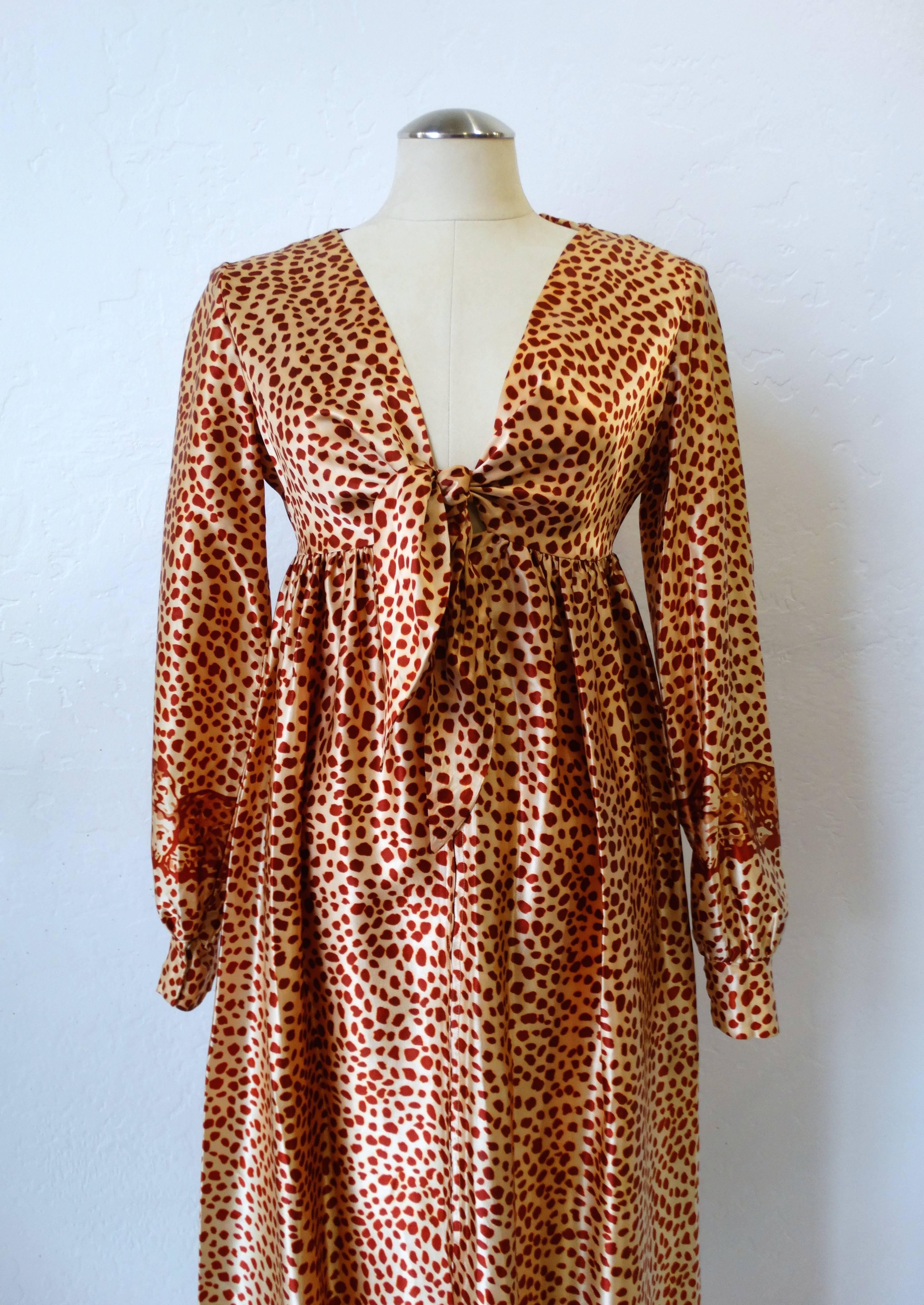 Take a walk on the wild side in our 1970s Saks Fifth Avenue leopard dress! Super silky satin printed with leopard dot print, accented with little leopards on the cuffs and hem. Sexy fit, v neckline with adjustable tie at the bust. Flattering long